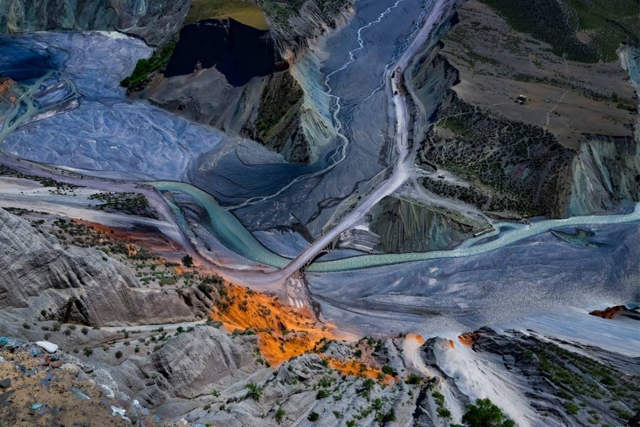 Aerial view of a colorful mountain landscape with rivers and a bridge HD Wallpaper