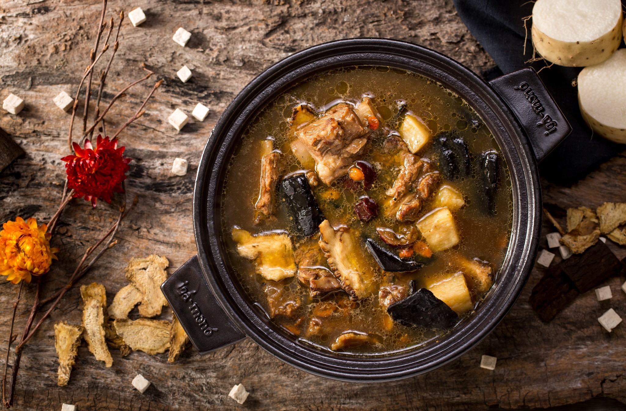 Herbal meat soup in a pot with ingredients HD Wallpaper