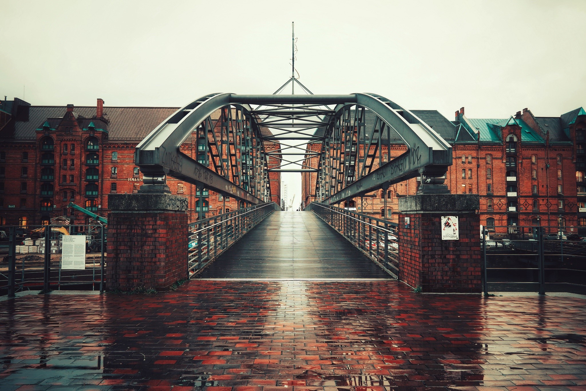 Bridge over wet brick pavement in Hamburg, Germany HD Wallpaper