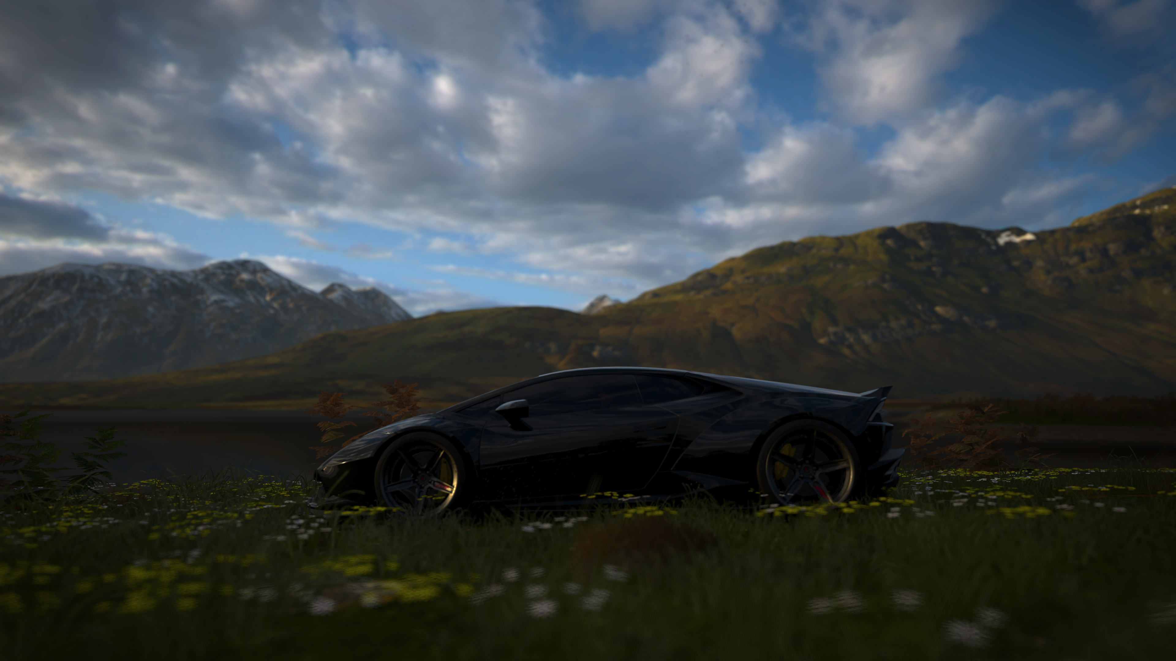 Black Lamborghini in a field with mountains HD Wallpaper