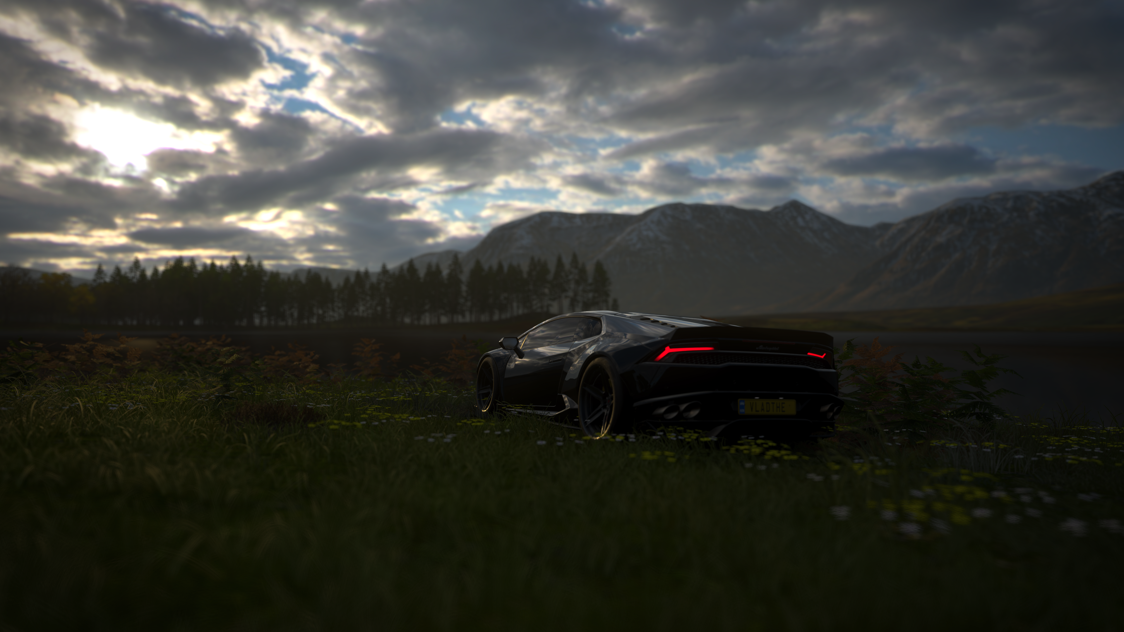Black Lamborghini in a field with mountains HD Wallpaper