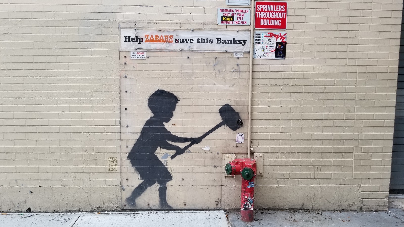 Banksy graffiti of child with sledgehammer on brick wall HD Wallpaper