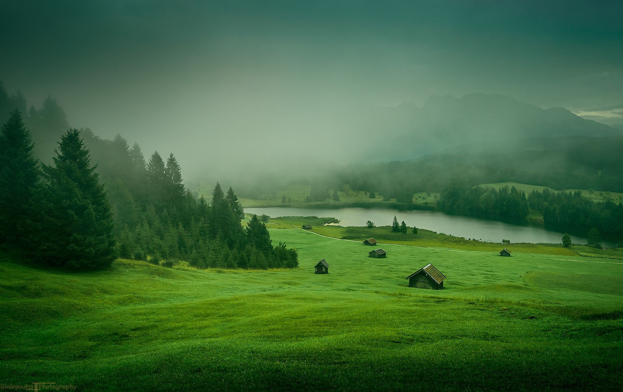 Misty landscape with cabins and lake HD Wallpaper