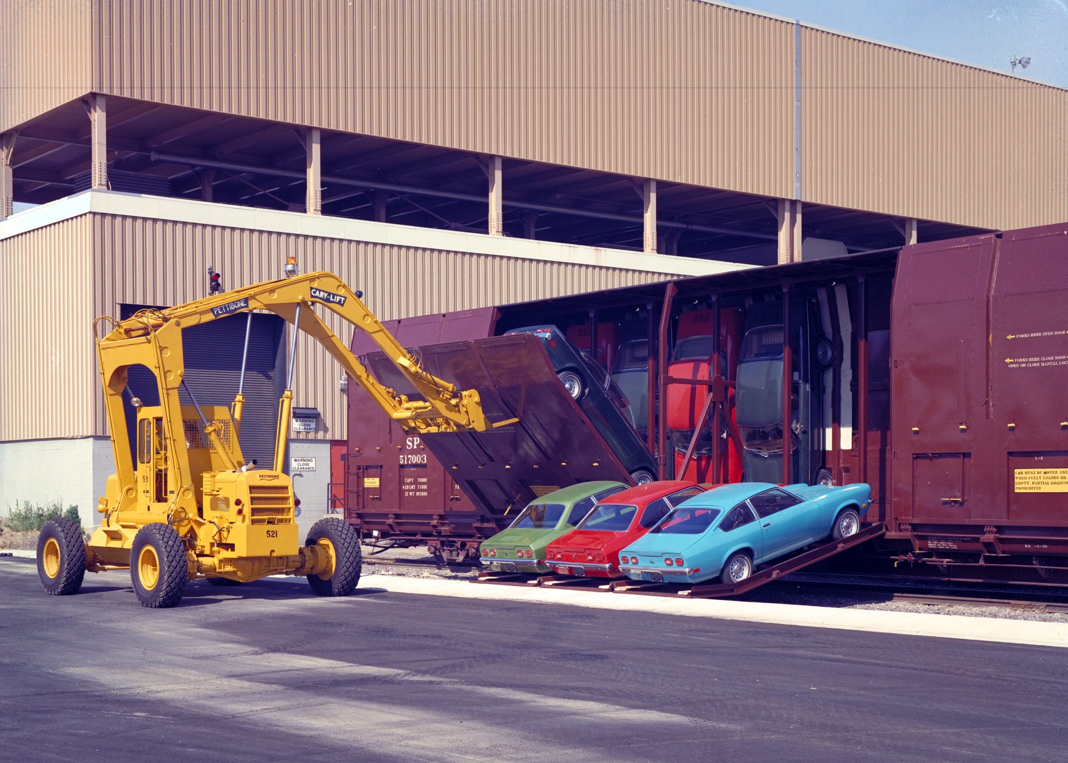 Yellow Cary-Lift loading cars onto a train HD Wallpaper