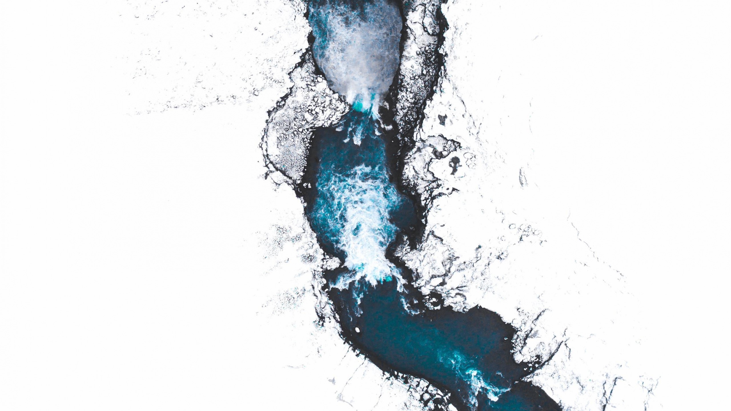 Aerial view of a river flowing through snow and ice in Iceland HD Wallpaper