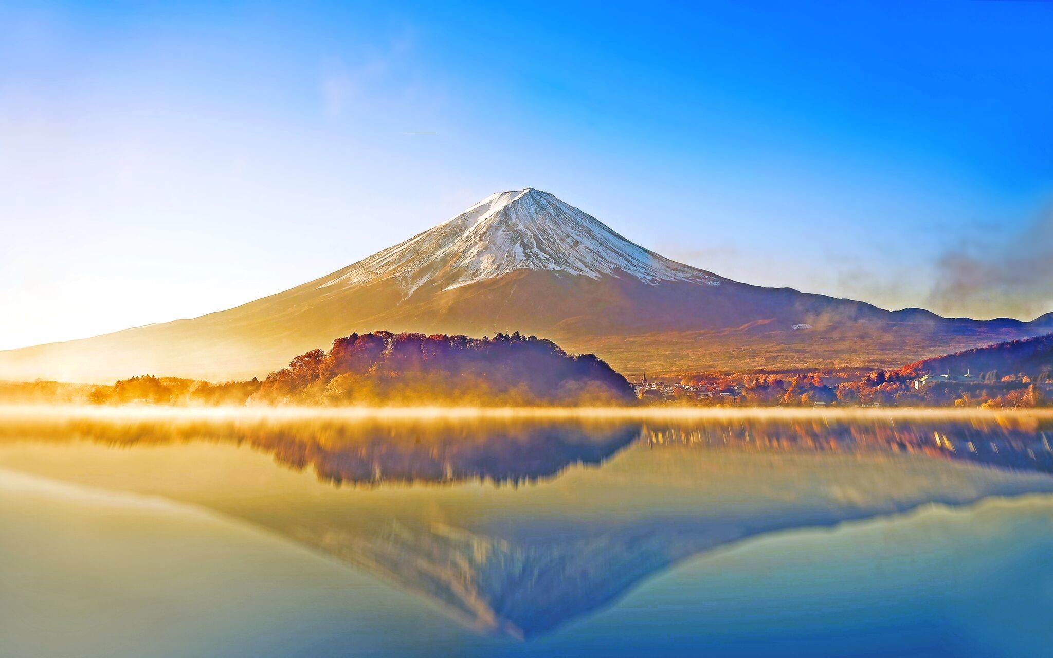 Mount Fuji reflected in a misty lake at sunrise HD Wallpaper