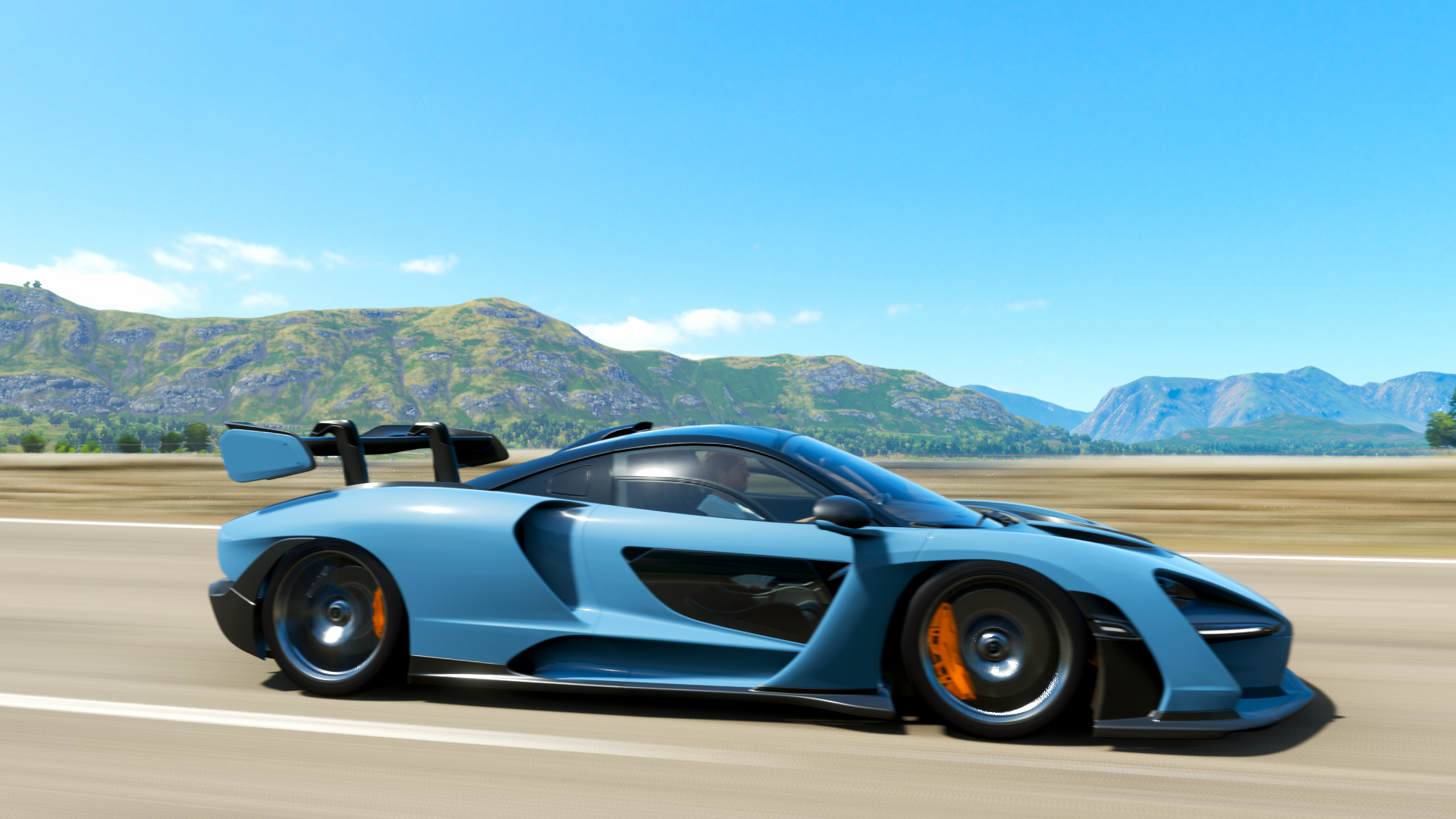 Blue McLaren Senna driving on a road in Forza Horizon 4 HD Wallpaper