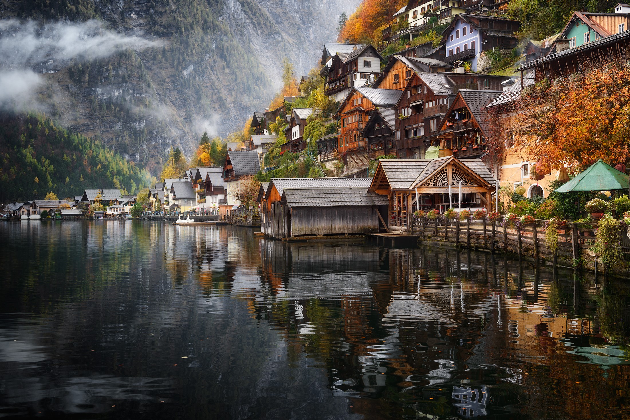Hallstatt village on a mountainside reflected in a lake HD Wallpaper