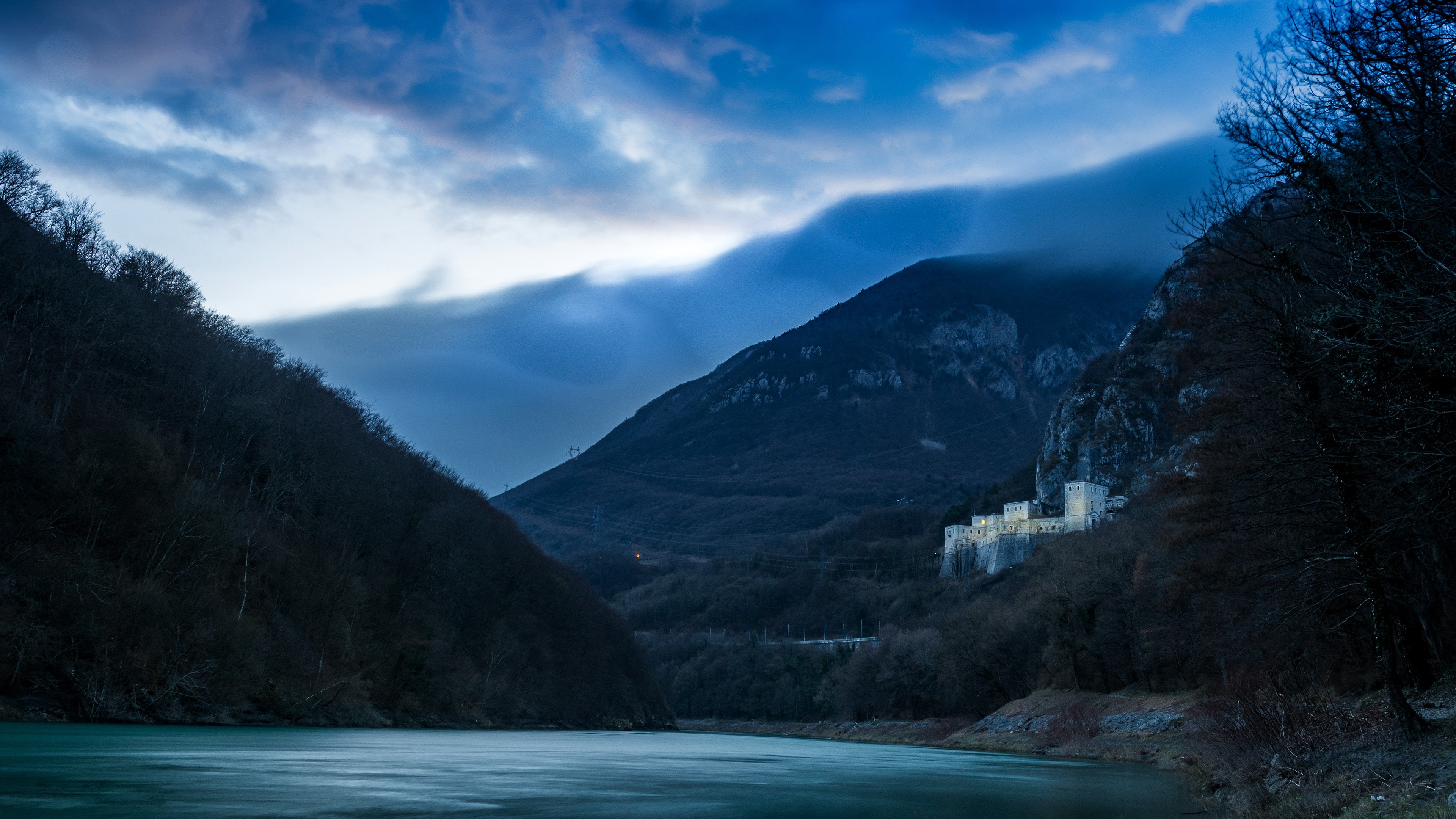 Castle on a mountain by a river at dusk HD Wallpaper
