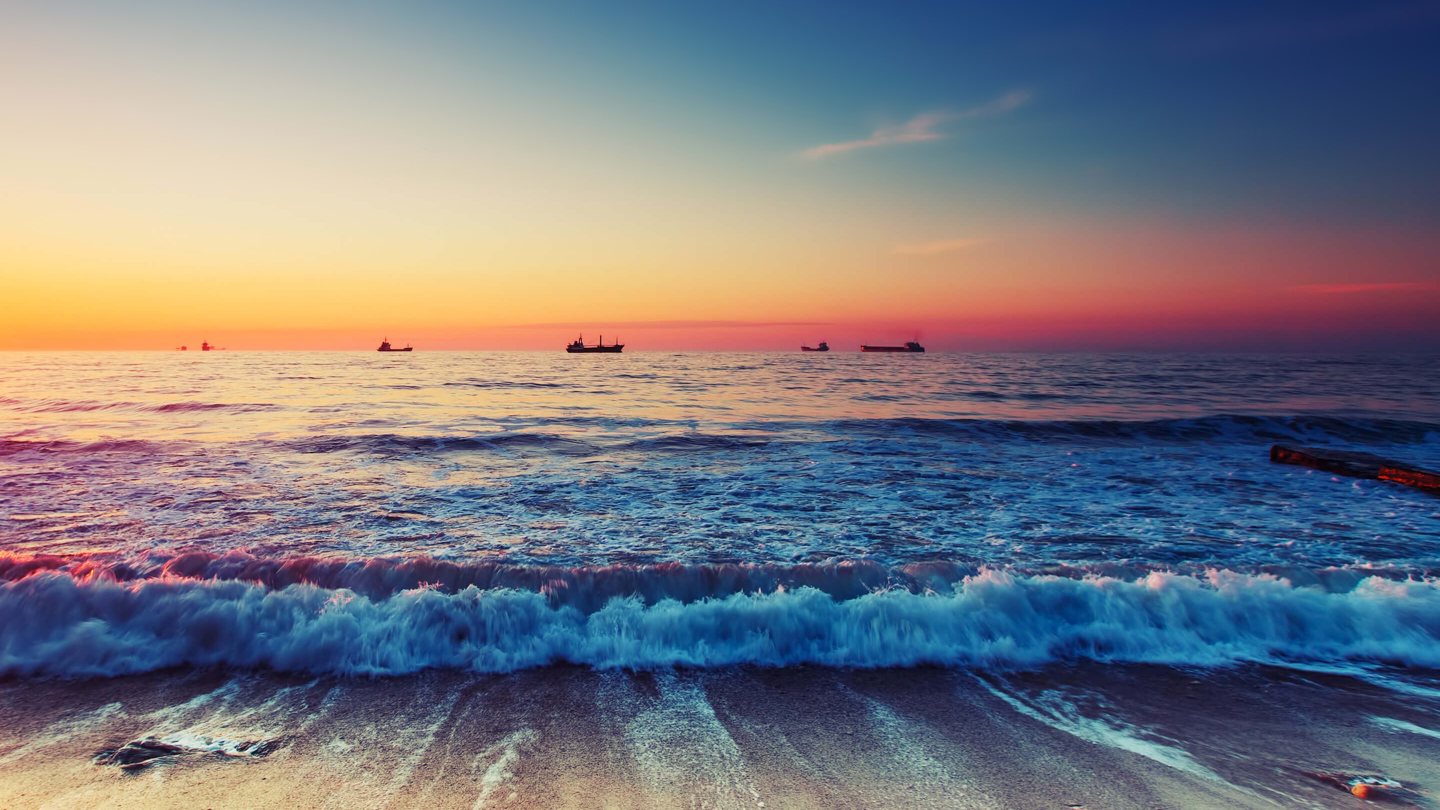 Ships on the horizon at sunrise over the sea HD Wallpaper