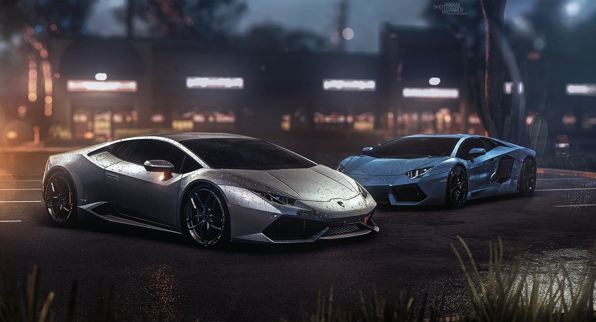 Two Lamborghinis parked on a wet street at night HD Wallpaper