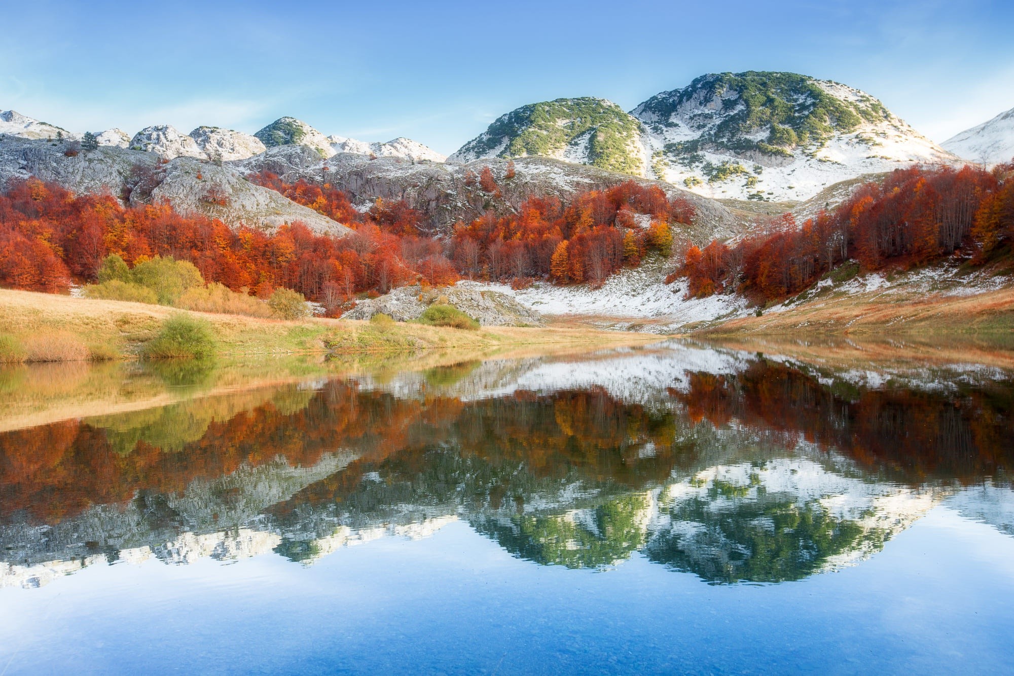 Autumn mountains reflected in a lake HD Wallpaper