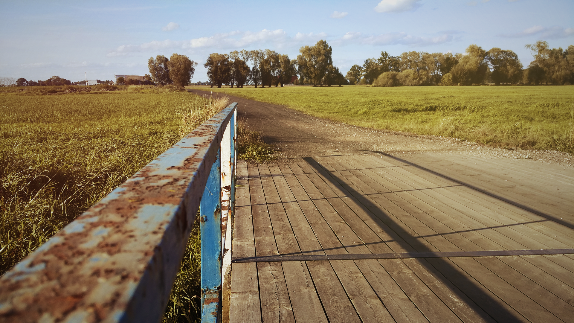 Wooden bridge with rusty railing over a field in Poland HD Wallpaper