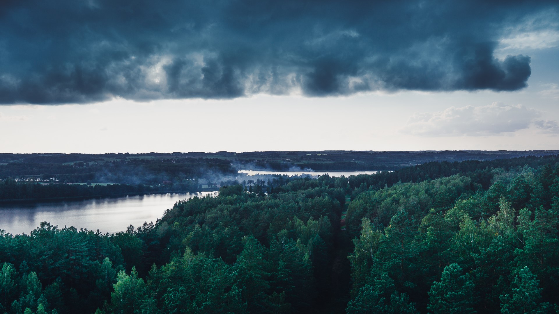 Dark Clouds Over a Forest and Lake Landscape HD Wallpaper