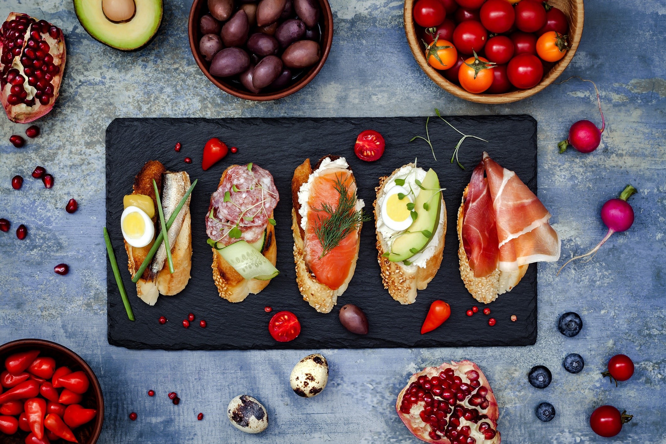 Assortment of gourmet open-faced sandwiches and appetizers HD Wallpaper