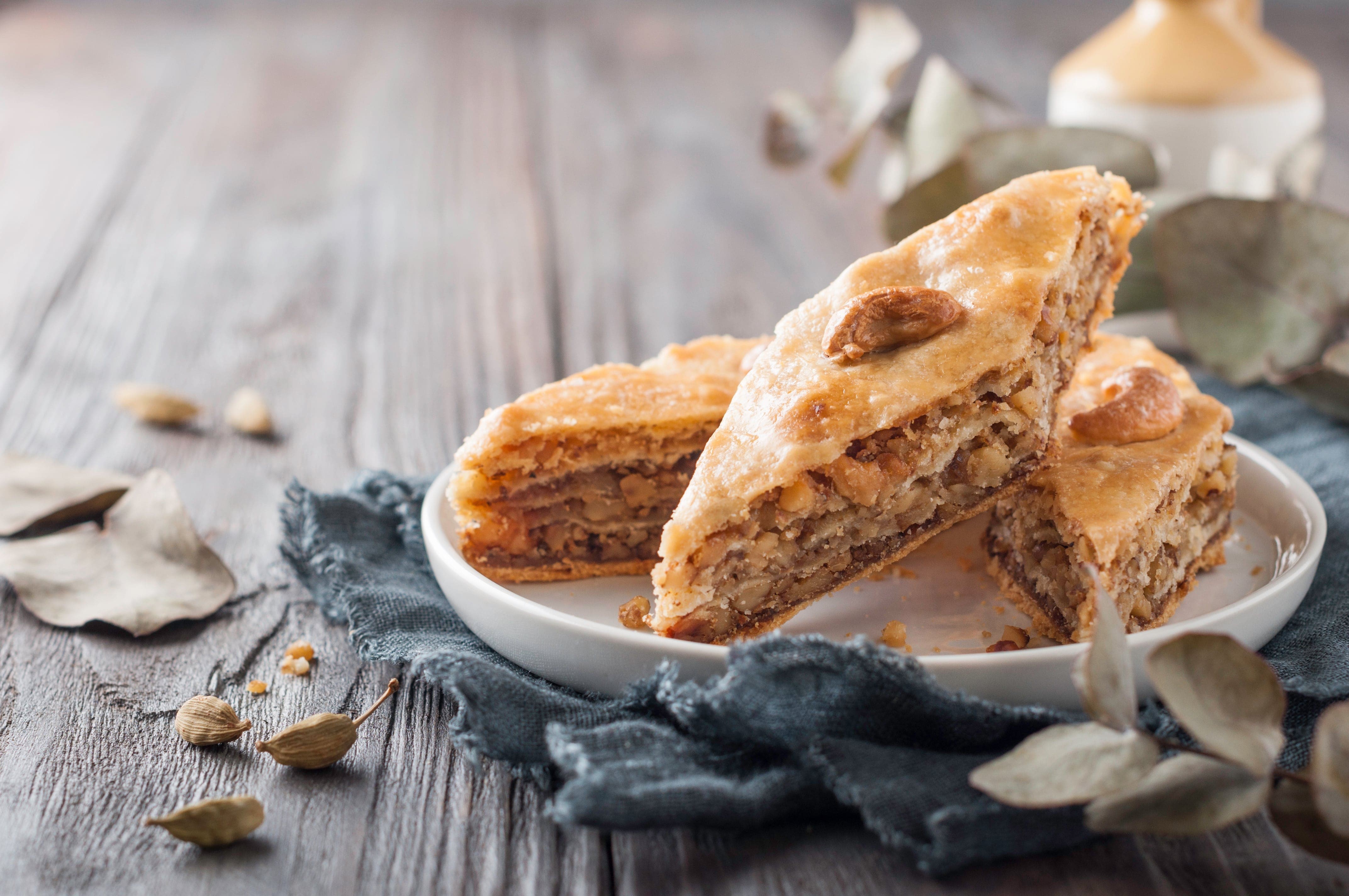 Baklava dessert on a wooden surface HD Wallpaper