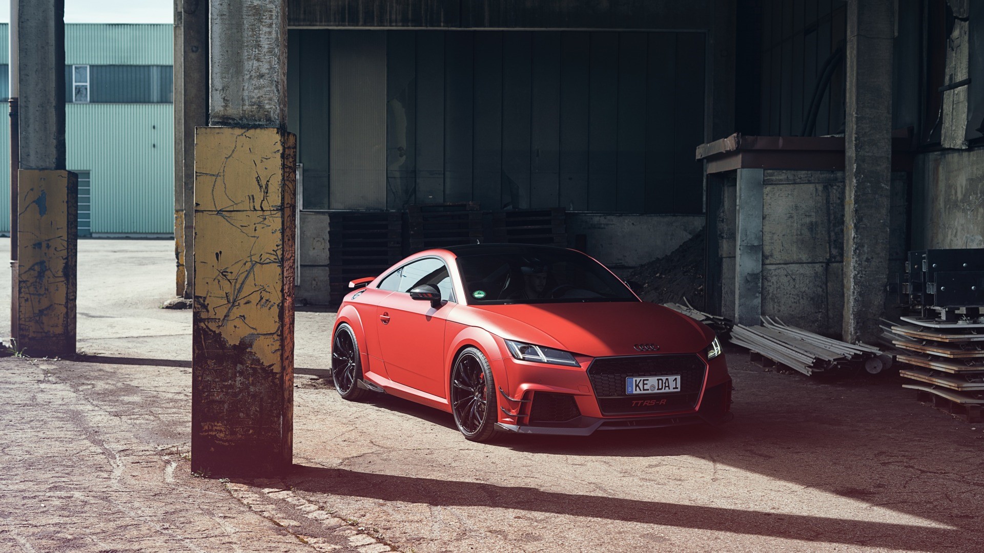 Red Audi TT RS parked in an industrial area HD Wallpaper