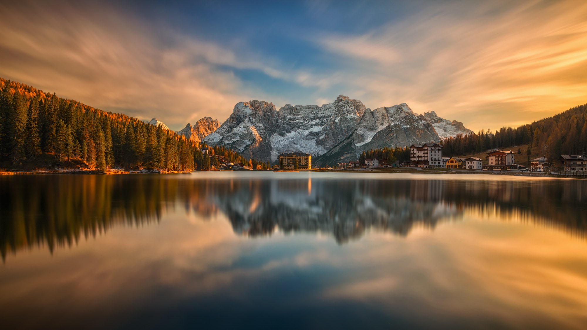 Lake with forest and snow-capped mountains at sunset HD Wallpaper