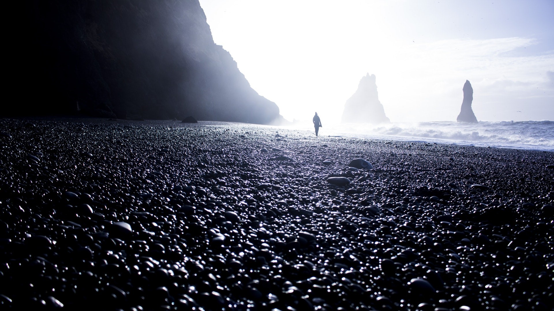 Person walking on Reynisfjara black sand beach, Iceland HD Wallpaper