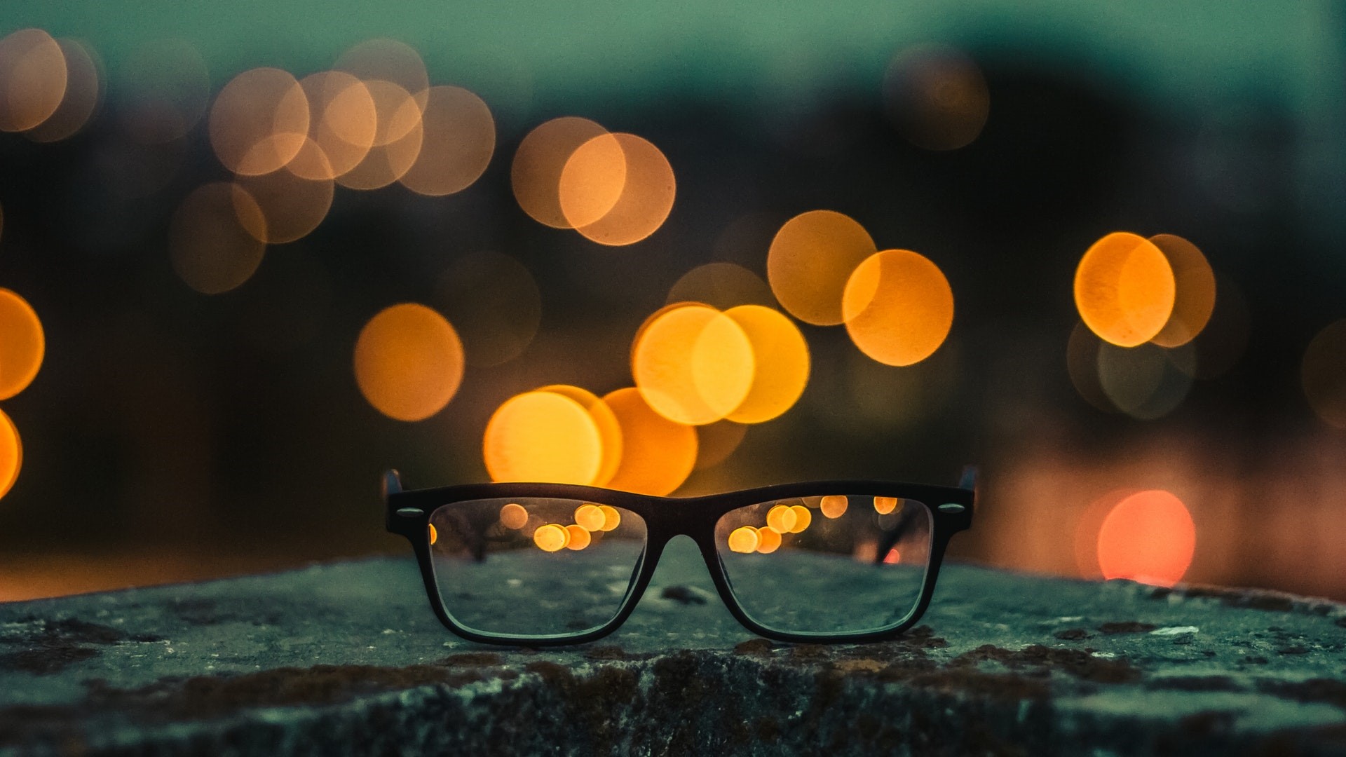 Glasses on a textured surface with bokeh lights HD Wallpaper