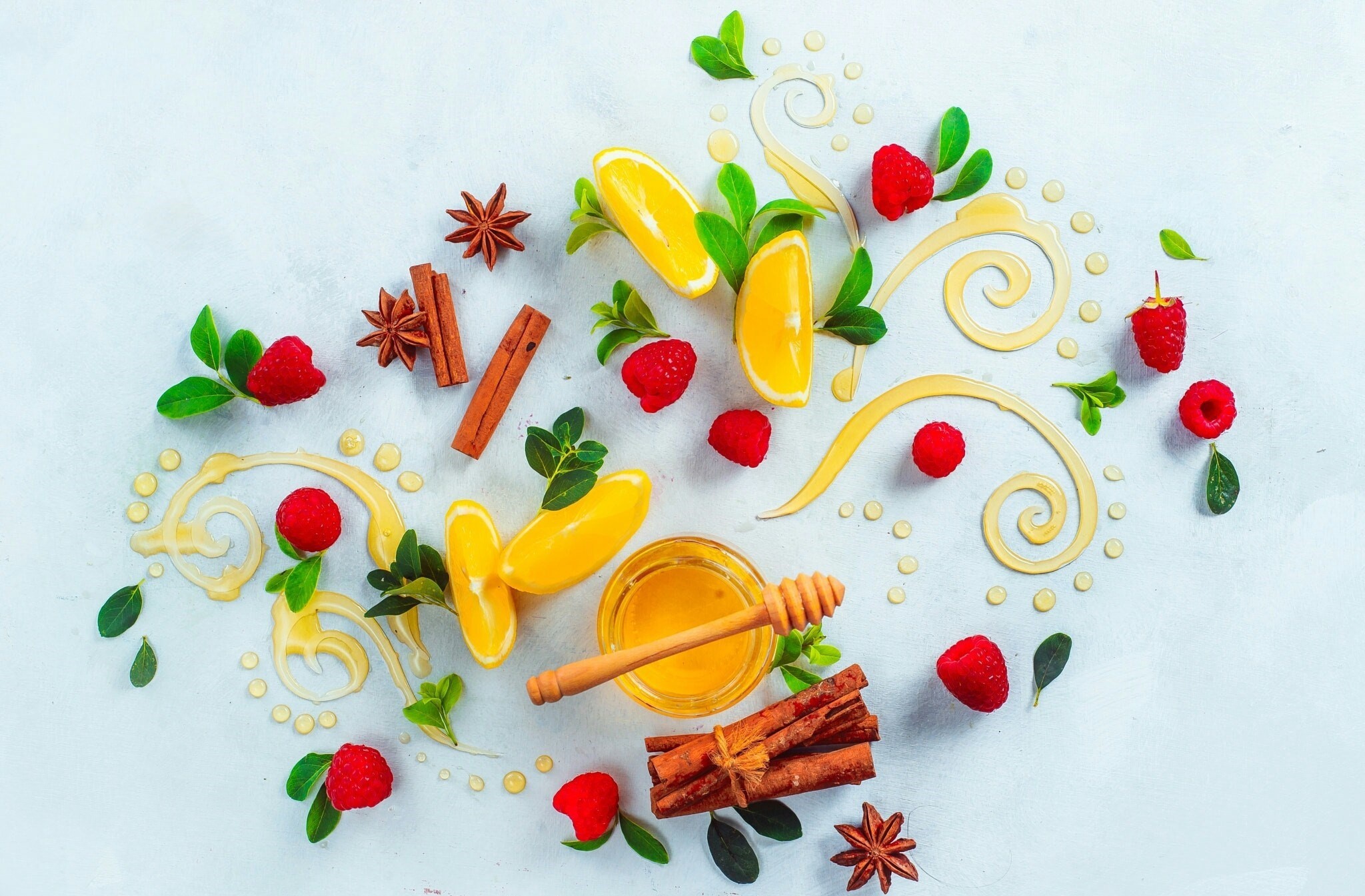 Honey, raspberries, oranges, cinnamon, and star anise on a light background HD Wallpaper