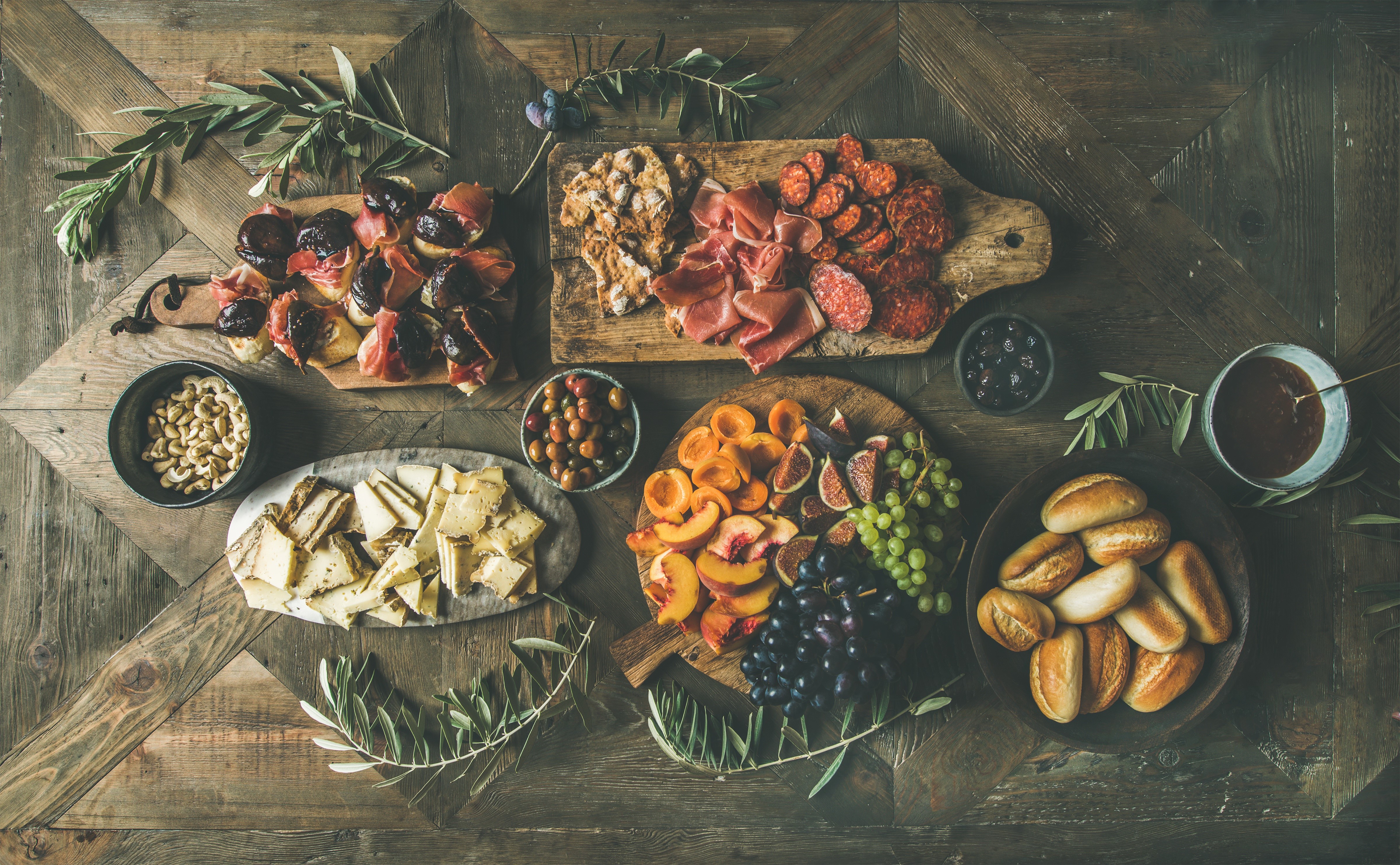 Charcuterie board with figs, meats, cheese, fruit, and bread HD Wallpaper