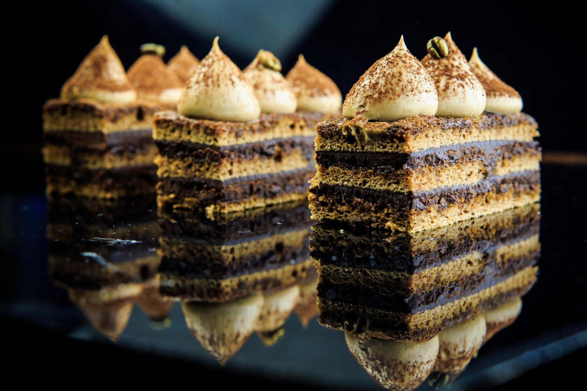 Chocolate layered cakes with cream topping and reflection HD Wallpaper