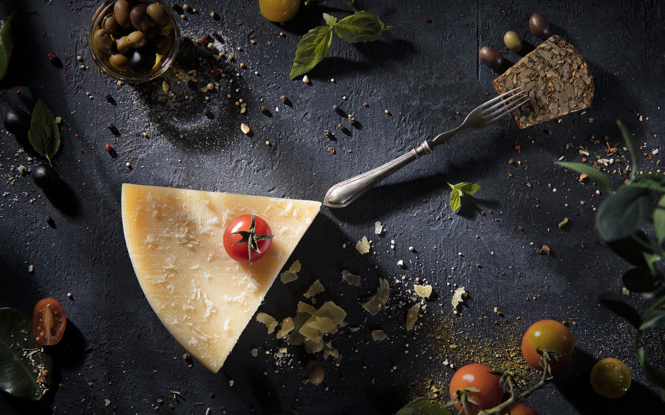 Parmesan cheese with tomatoes, olives, and herbs HD Wallpaper
