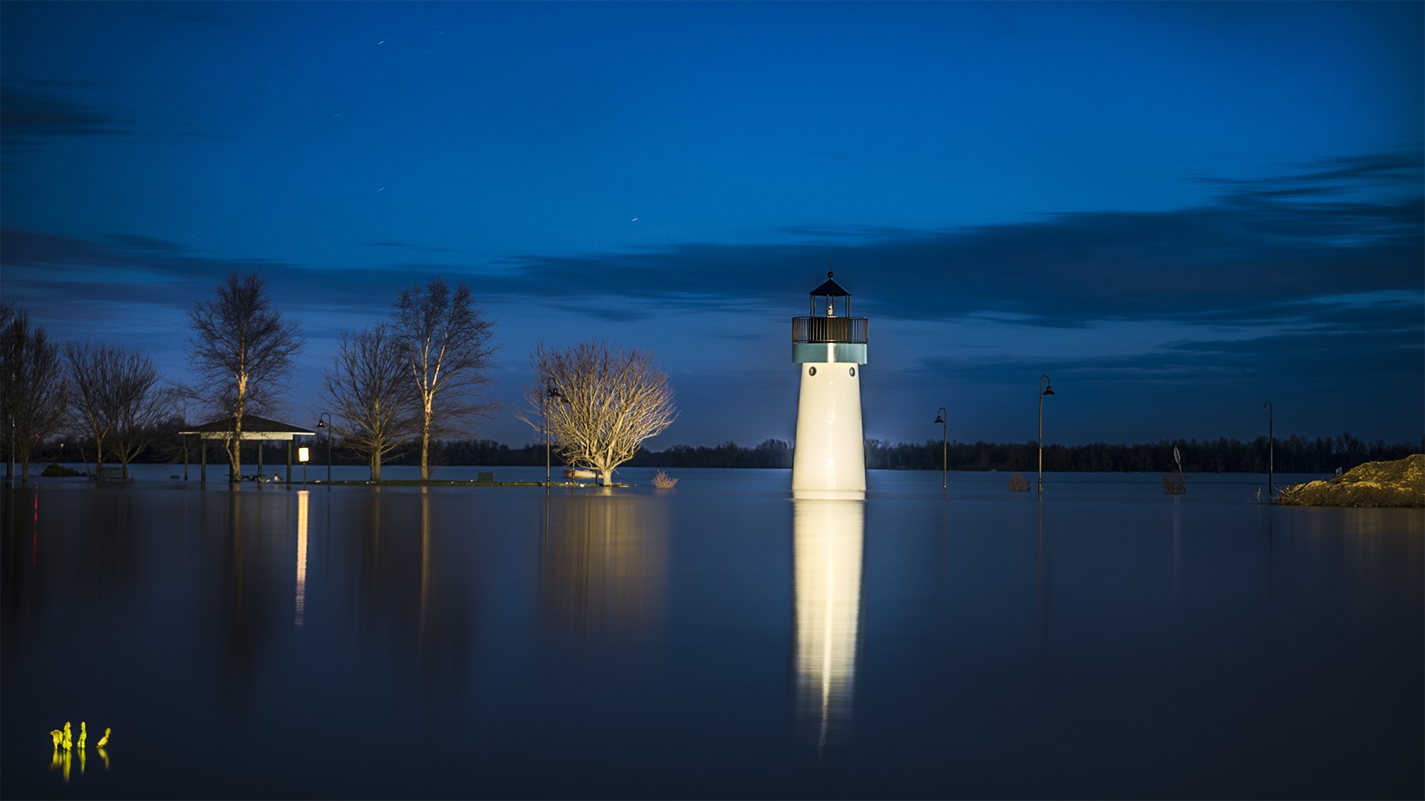 Flooded landscape with lighthouse at night HD Wallpaper