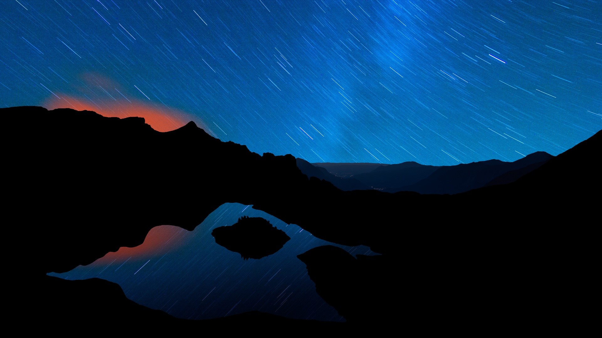 Night landscape with star trails over mountains and lake reflection HD Wallpaper