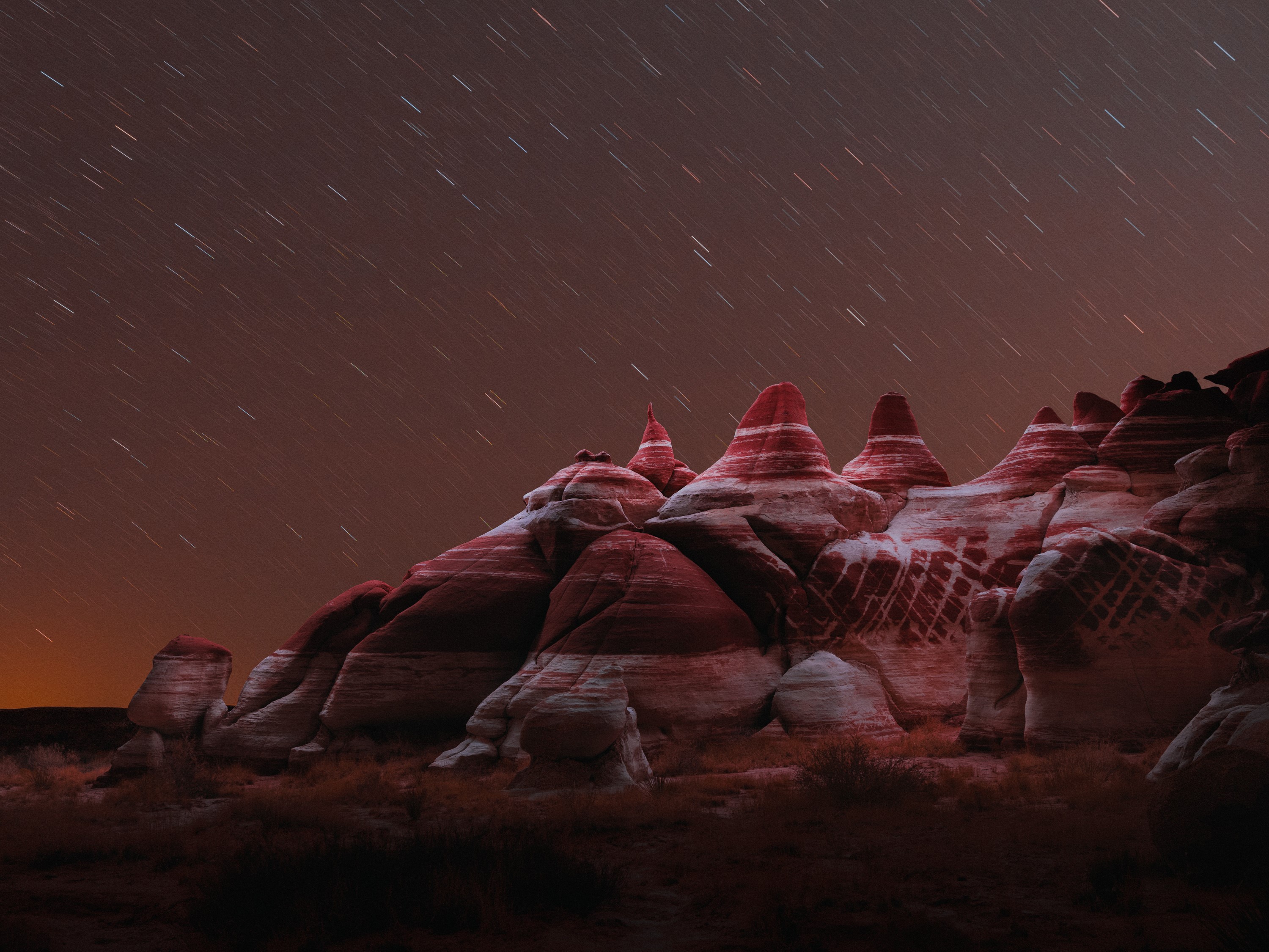 Night landscape photography of rock formations with star trails HD Wallpaper