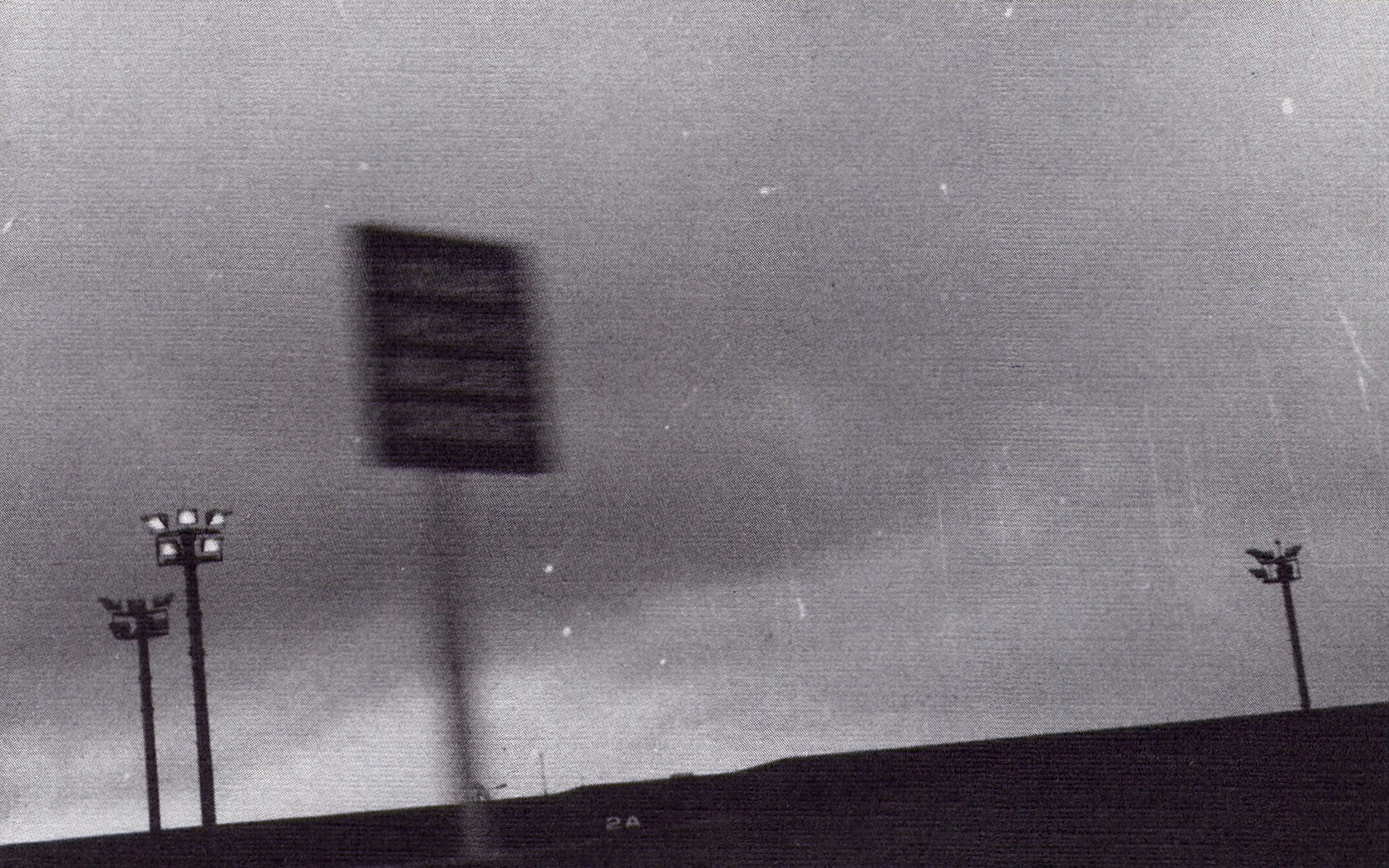 Blurred sign and stadium lights at dusk HD Wallpaper