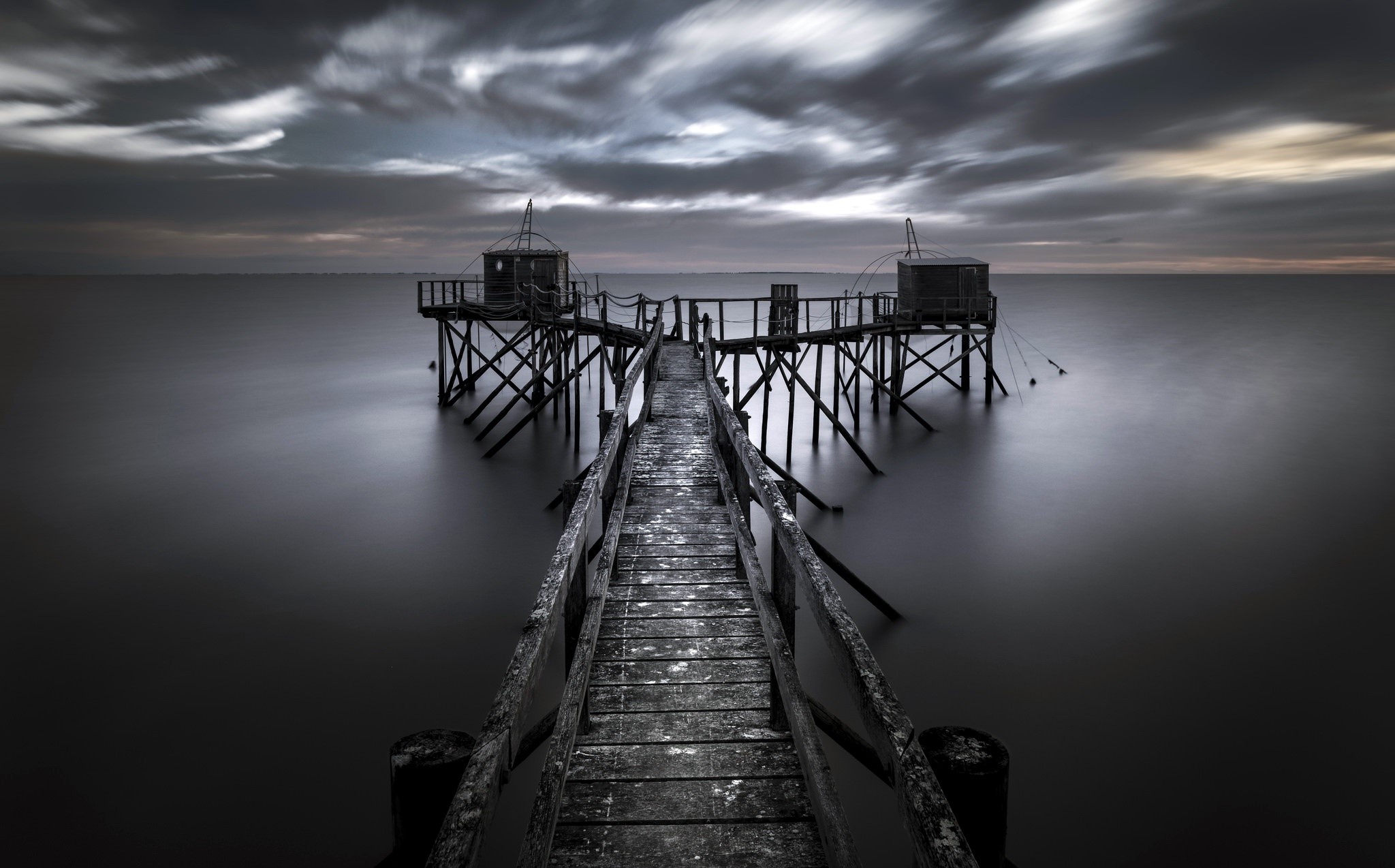 Wooden pier with fishing huts over the sea HD Wallpaper
