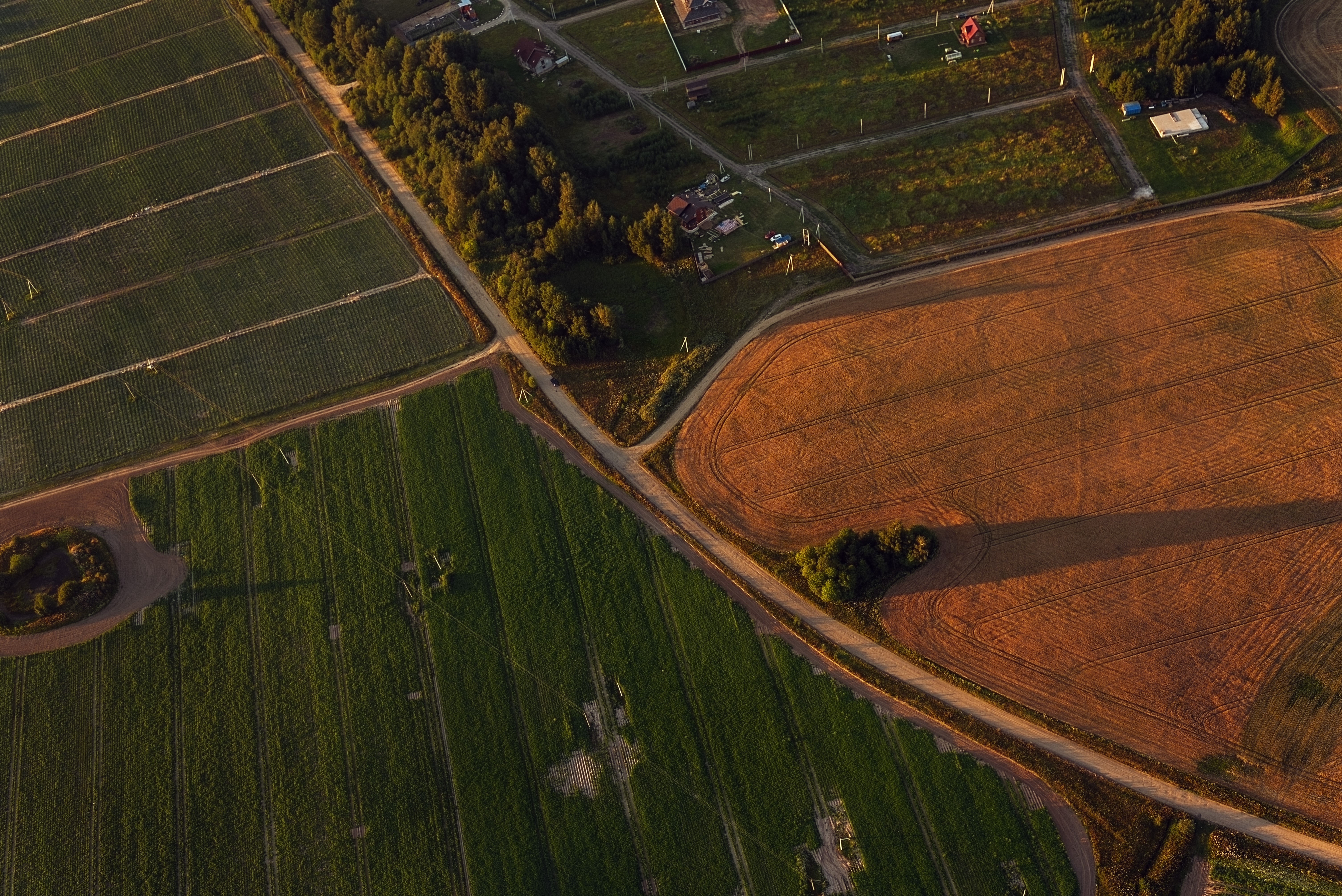 Aerial view of agricultural fields at sunset HD Wallpaper