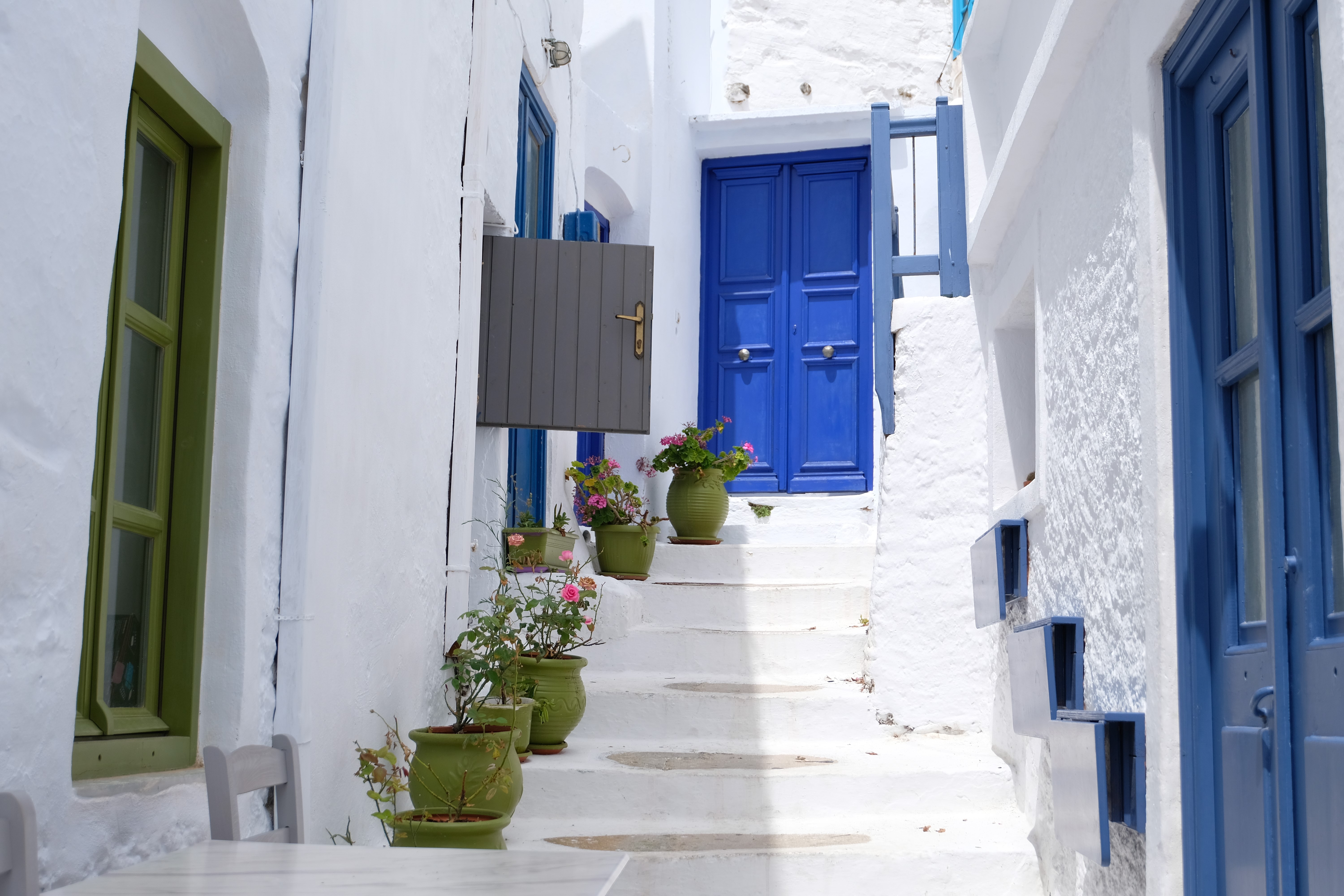 White alley with blue doors and green window in Greece HD Wallpaper