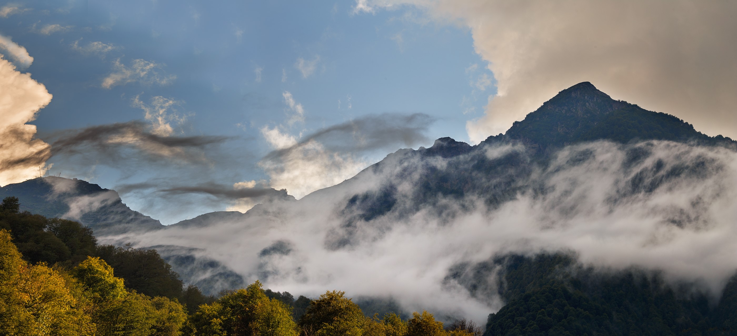 Caucasus Mountains shrouded in mist and clouds HD Wallpaper