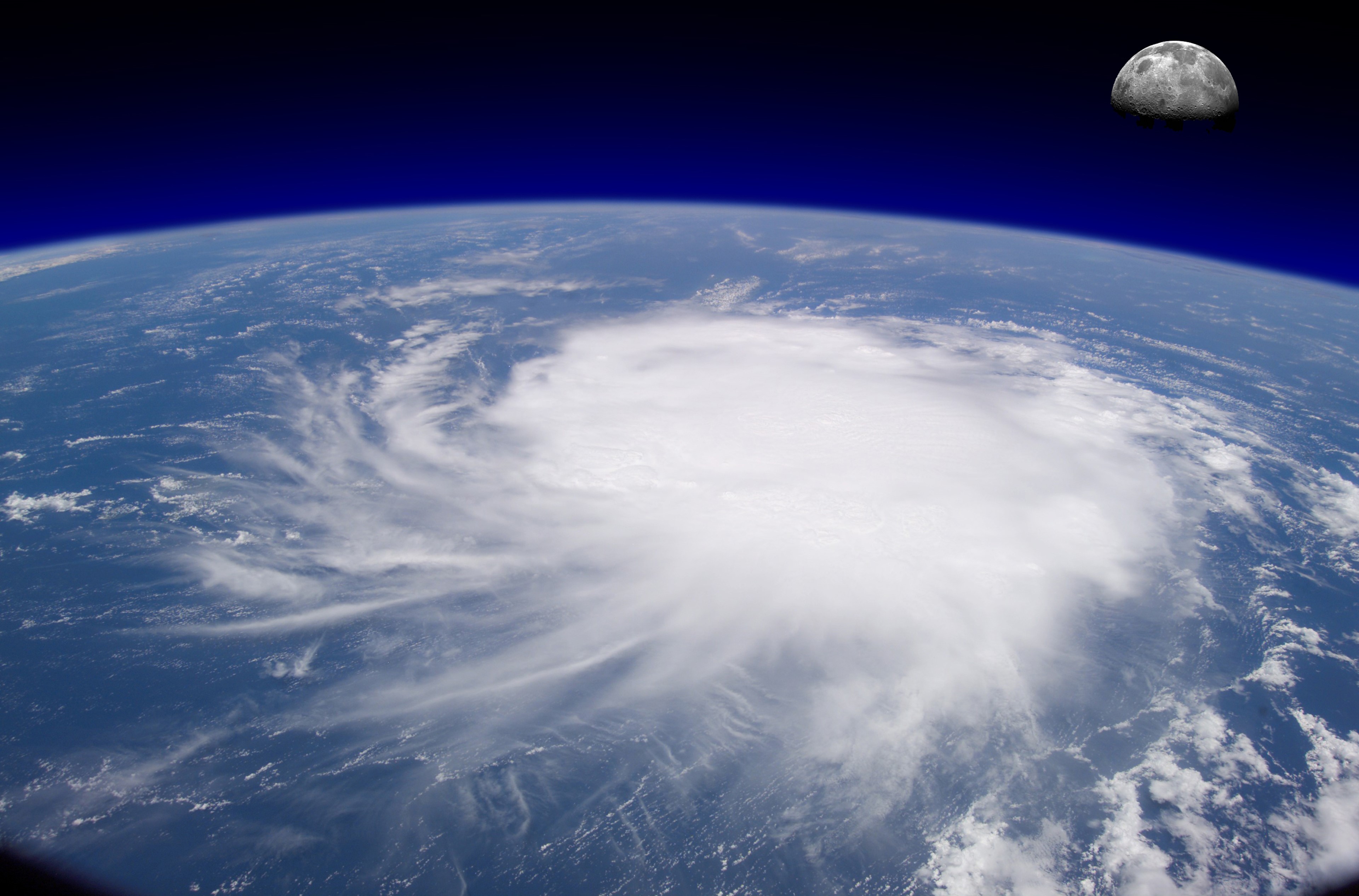 Hurricane over Earth with Moon HD Wallpaper