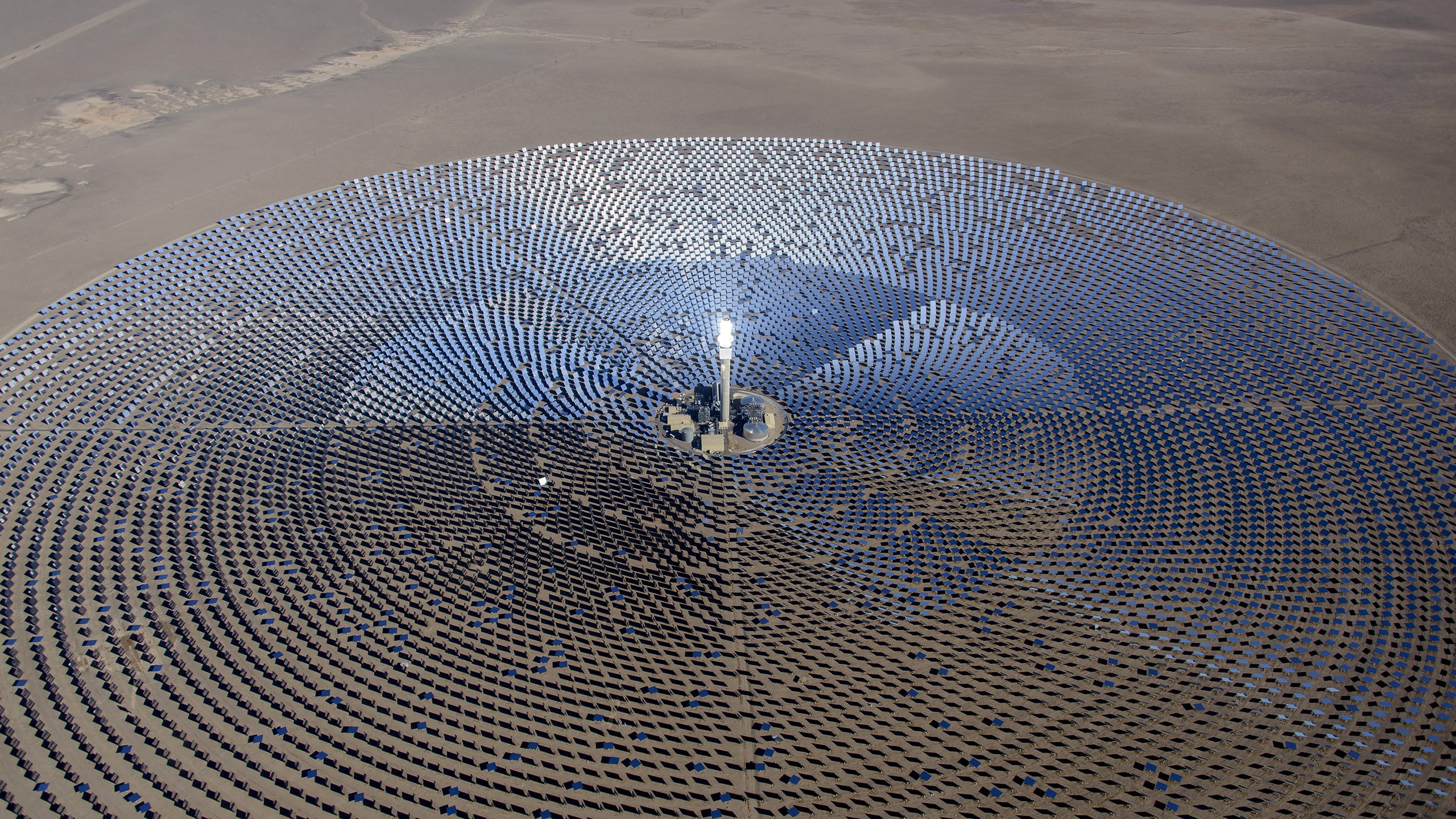 Aerial view of a solar power plant in a desert HD Wallpaper