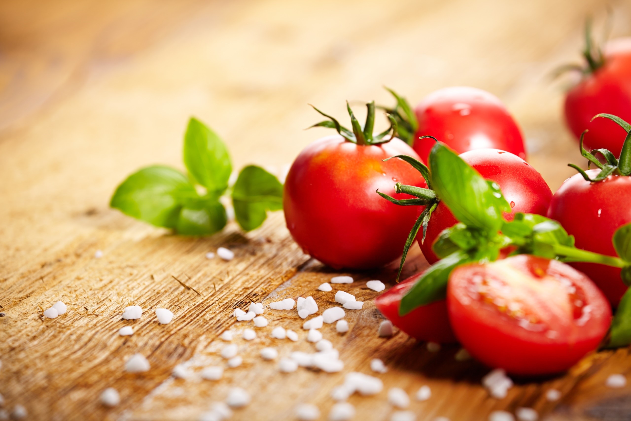 Tomatoes and basil on a wooden board with salt HD Wallpaper