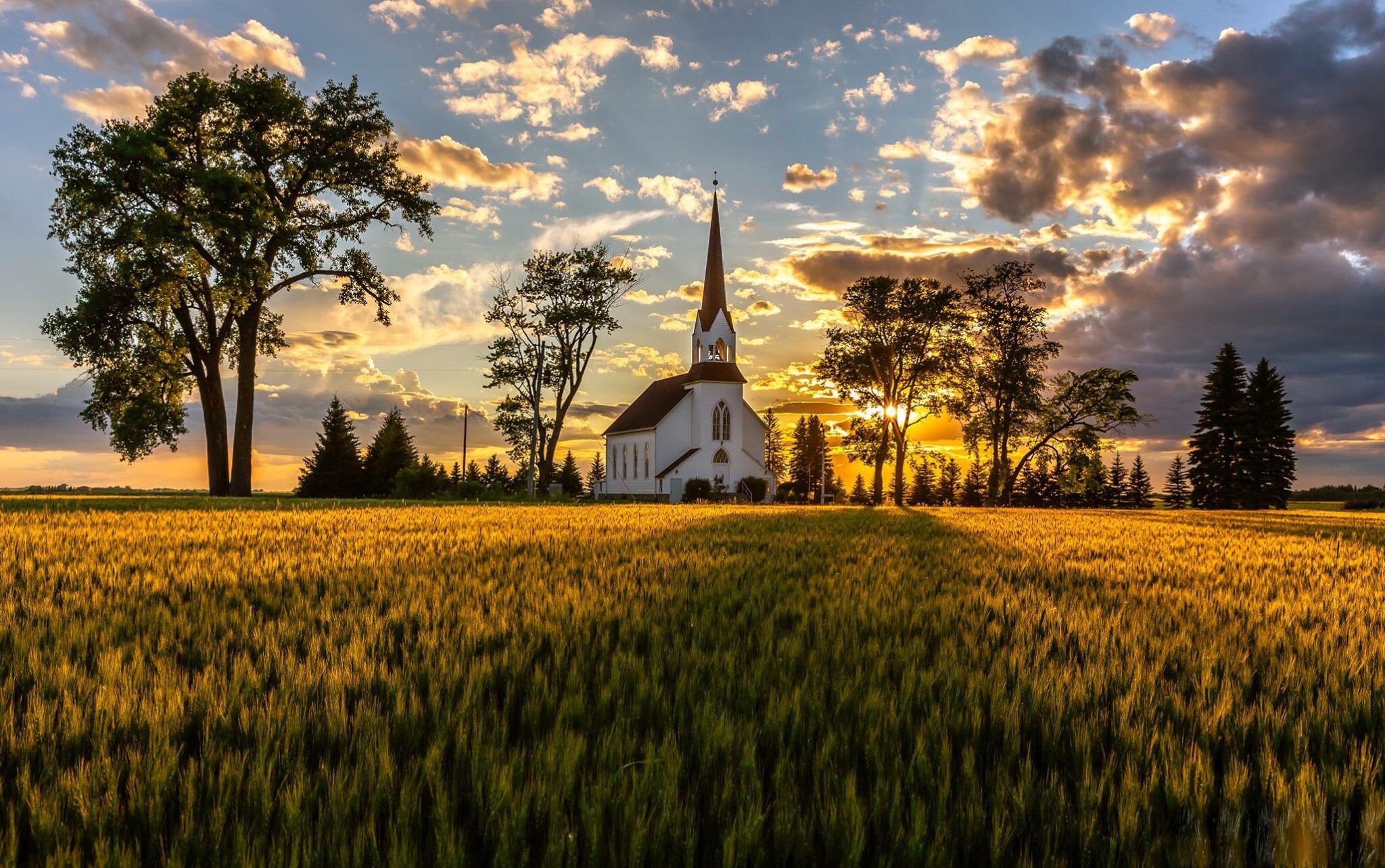 Church in a wheat field at sunset HD Wallpaper