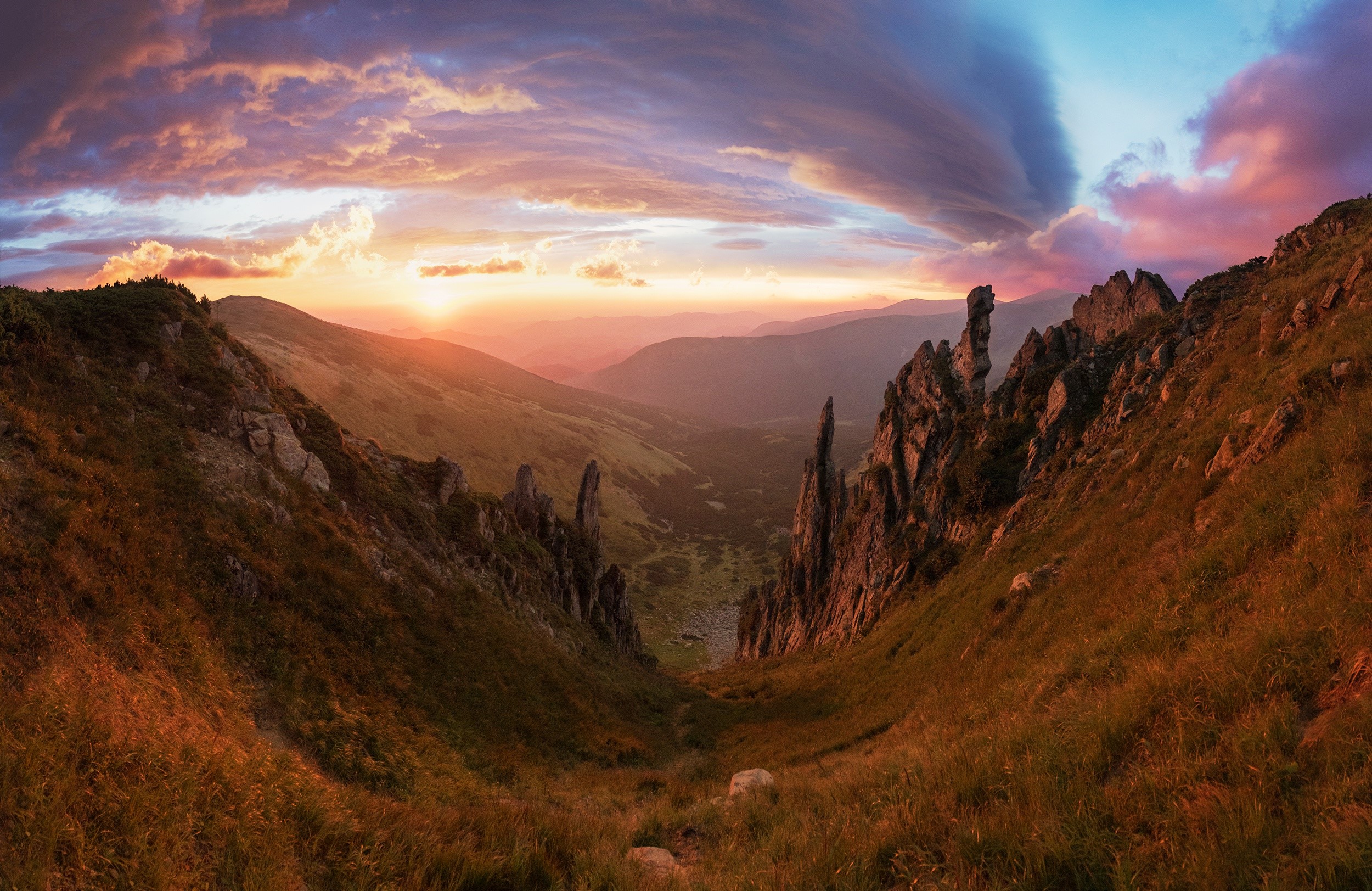Mountain valley at sunset with dramatic clouds HD Wallpaper