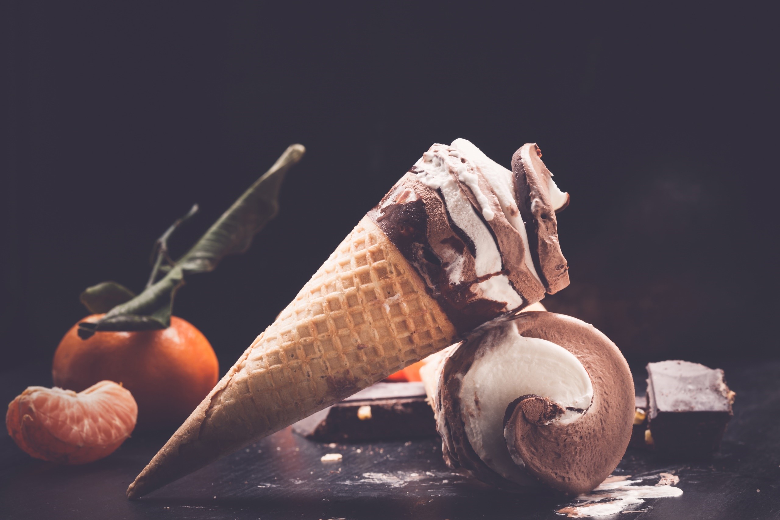 Chocolate and vanilla ice cream cones with orange and chocolate HD Wallpaper