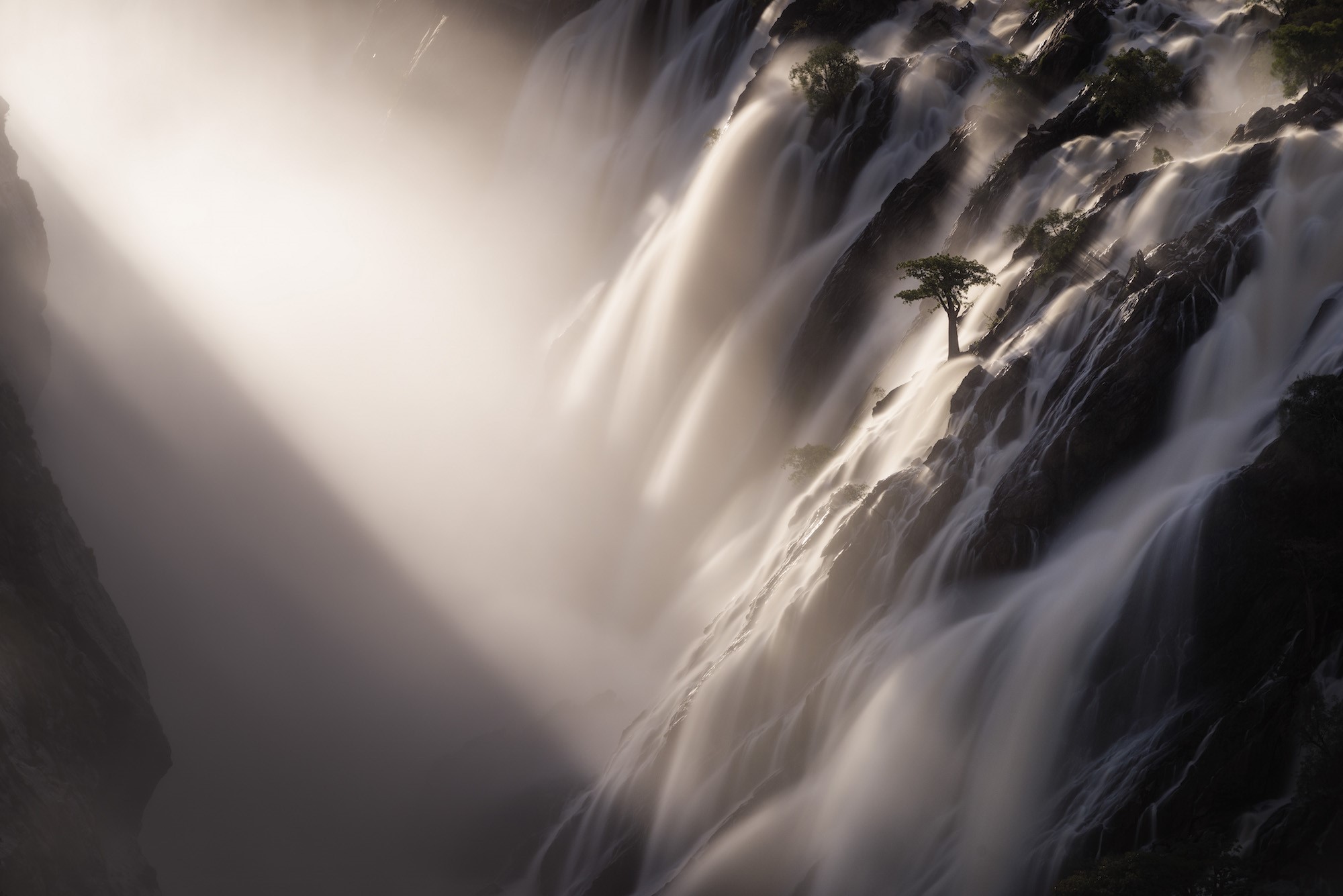 Waterfall with a lone tree and sun rays in Namibia HD Wallpaper