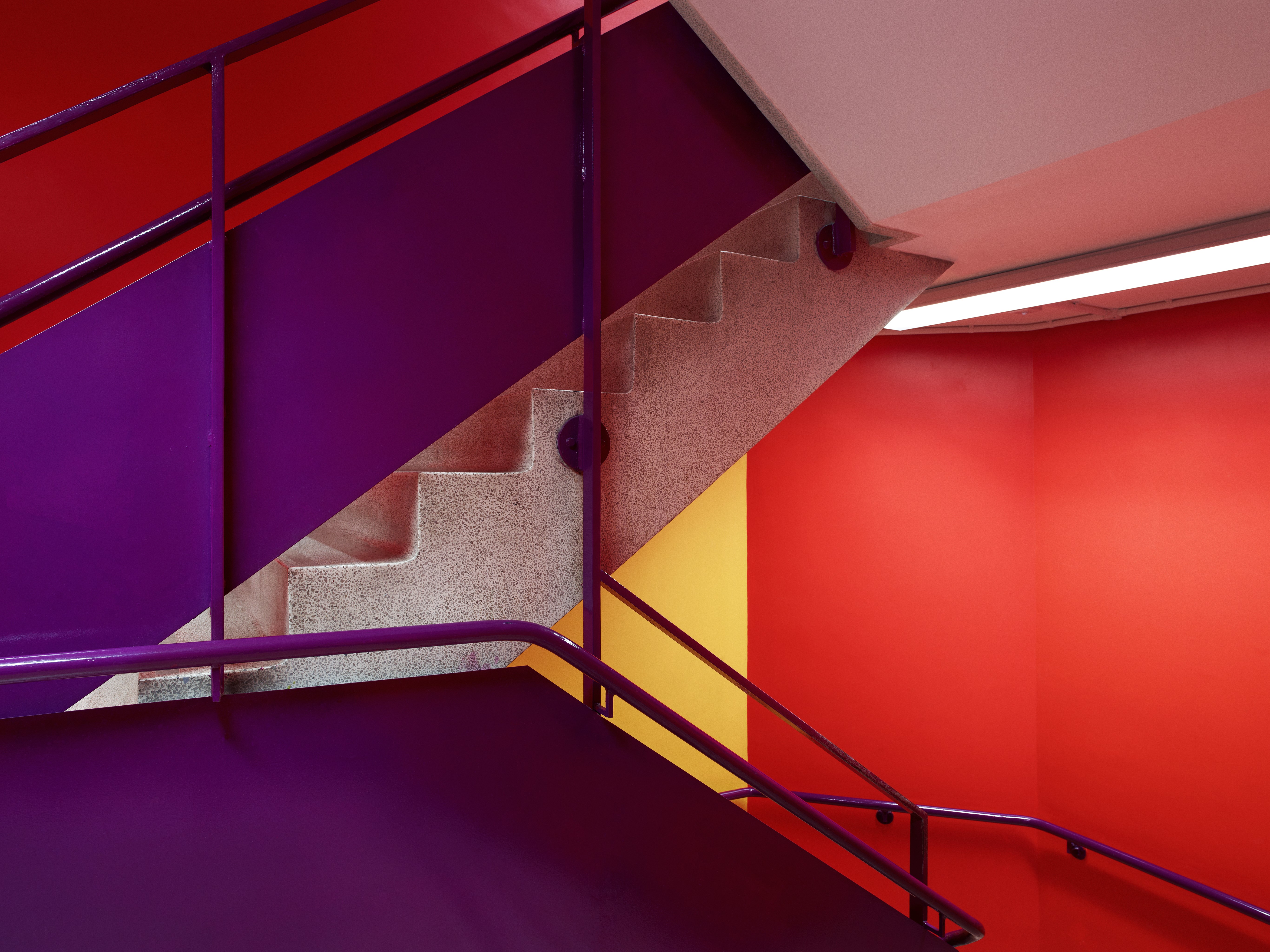 Colorful indoor stairs with red and purple walls HD Wallpaper
