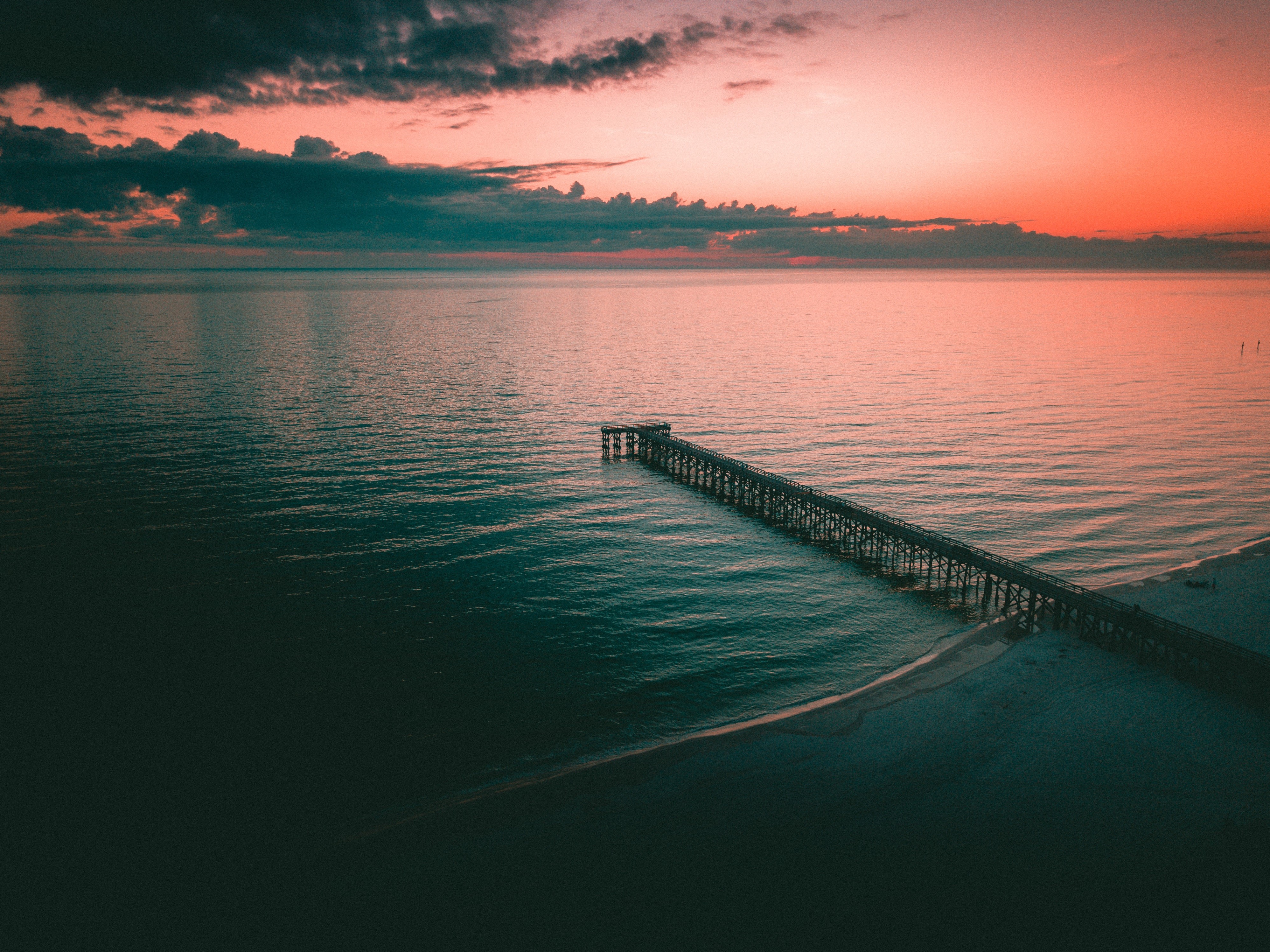 Aerial view of a pier at sunset HD Wallpaper