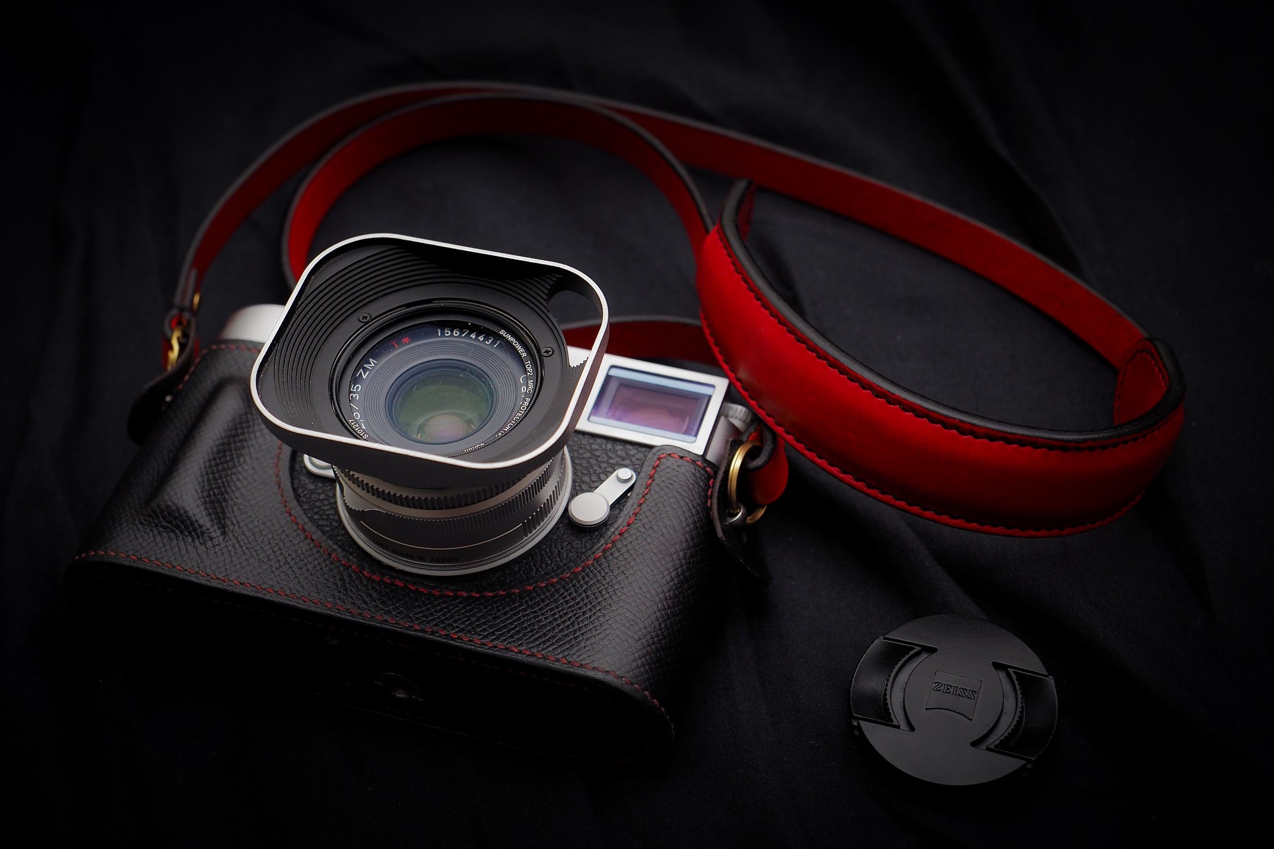 Leica camera with red strap and lens cap HD Wallpaper