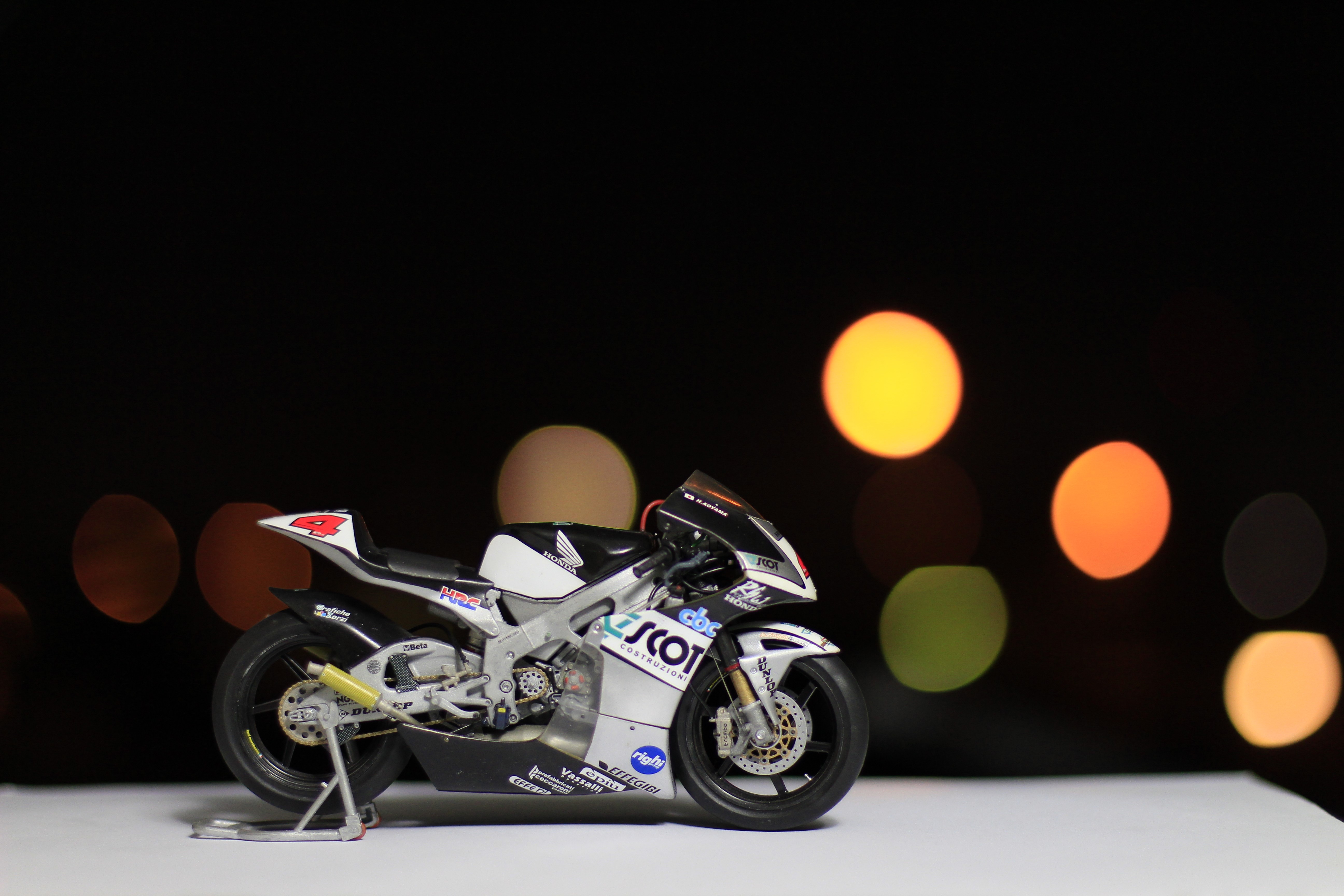 4K Toy motorcycle with bokeh background HD Wallpaper