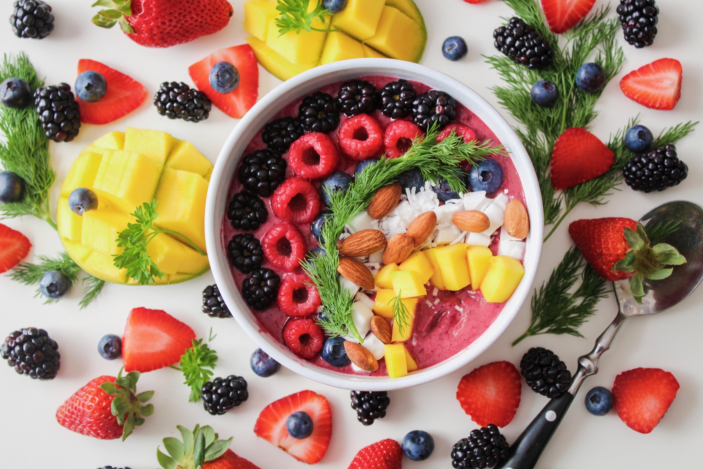 Fruit smoothie bowl with berries, mango, and nuts HD Wallpaper
