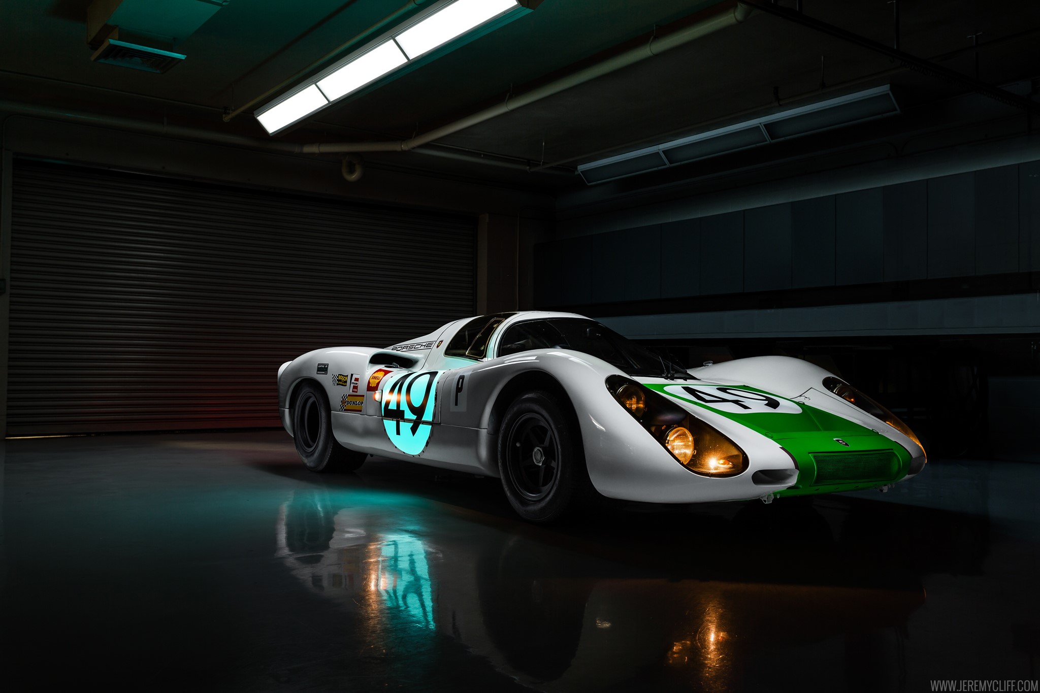 White and green Porsche race car with number 49 HD Wallpaper