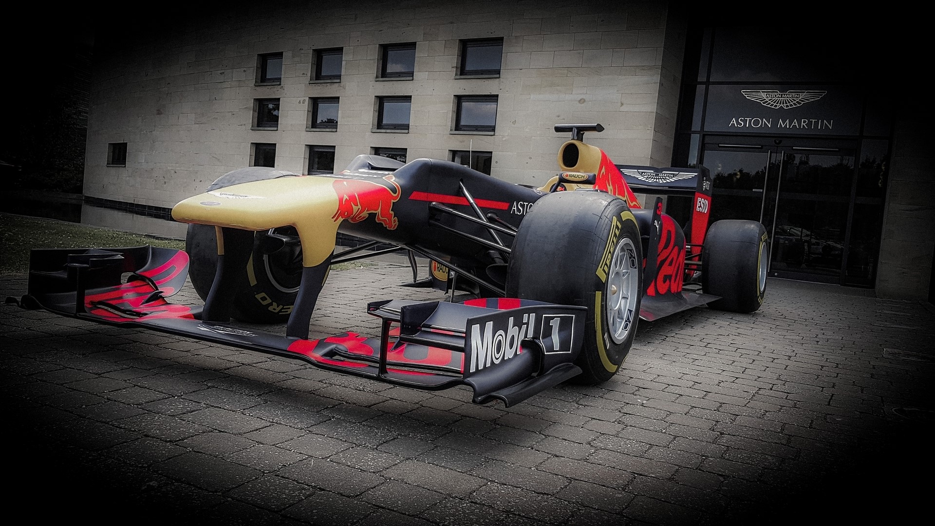 Red Bull Formula 1 car at Aston Martin building HD Wallpaper